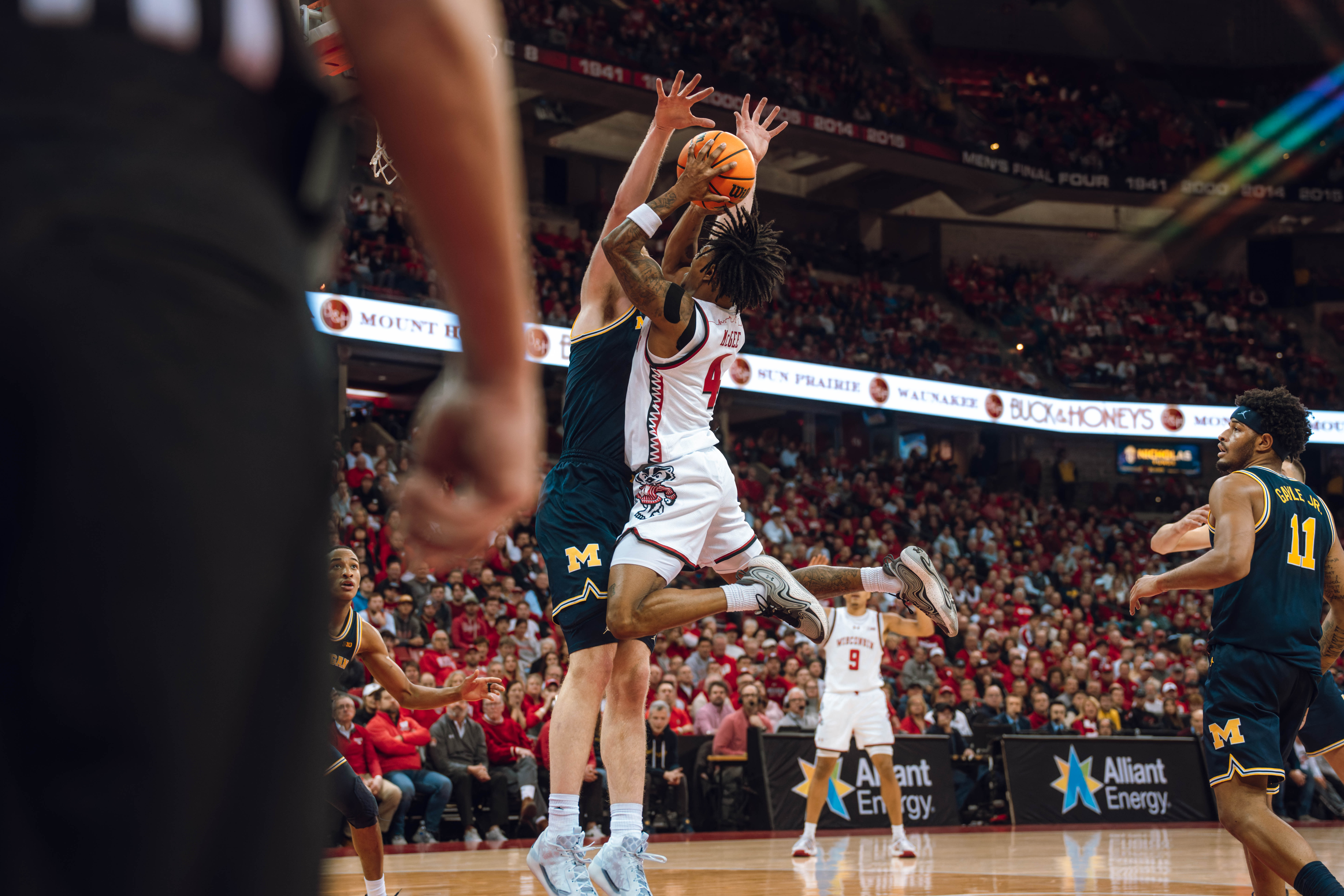 Wisconsin Badgers guard Kamari McGee #4 elevates to draw the and one against the Wolverines at the Kohl Center on December 03, 2024 in Madison, Wisconsin. Photography by Ross Harried for Second Crop Sports.