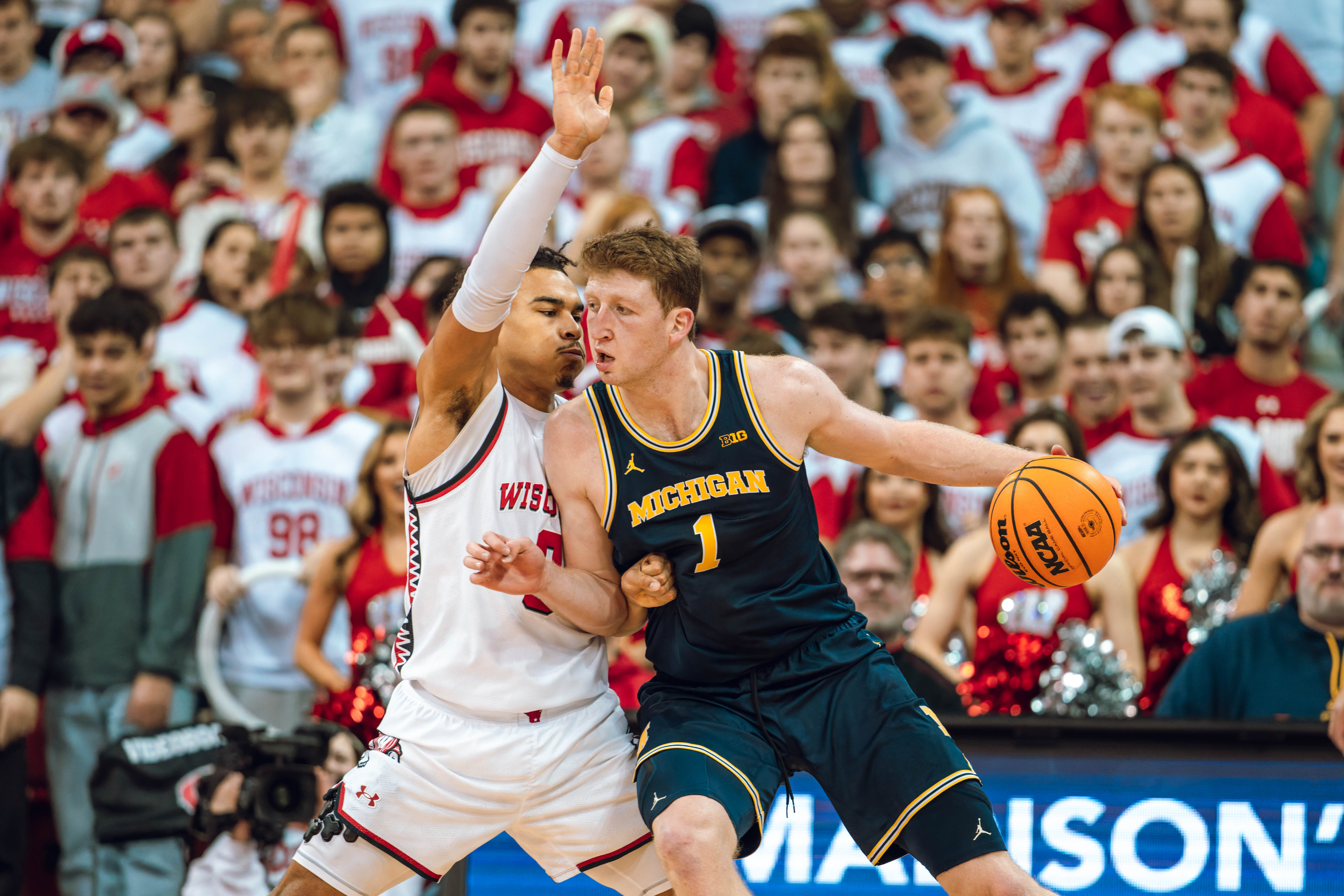 Wisconsin Badgers guard John Tonje #9 defends Michigan Wolverines center Danny Wolf #1 at the Kohl Center on December 03, 2024 in Madison, Wisconsin. Photography by Ross Harried for Second Crop Sports.