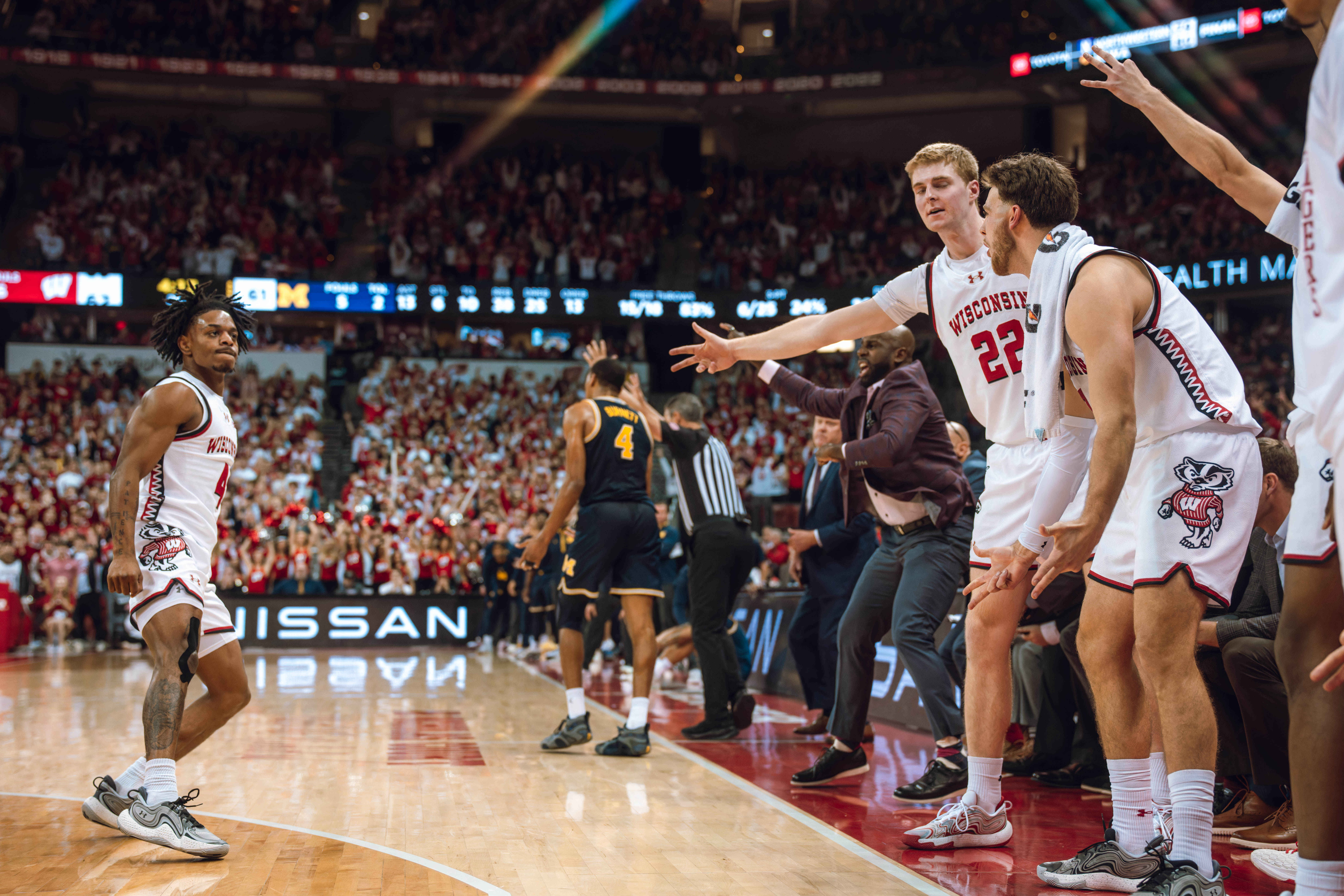 Wisconsin Badgers guard Kamari McGee #4 looks at the bench after draining a three pointer against the Michigan Wolverines at the Kohl Center on December 03, 2024 in Madison, Wisconsin. Photography by Ross Harried for Second Crop Sports.