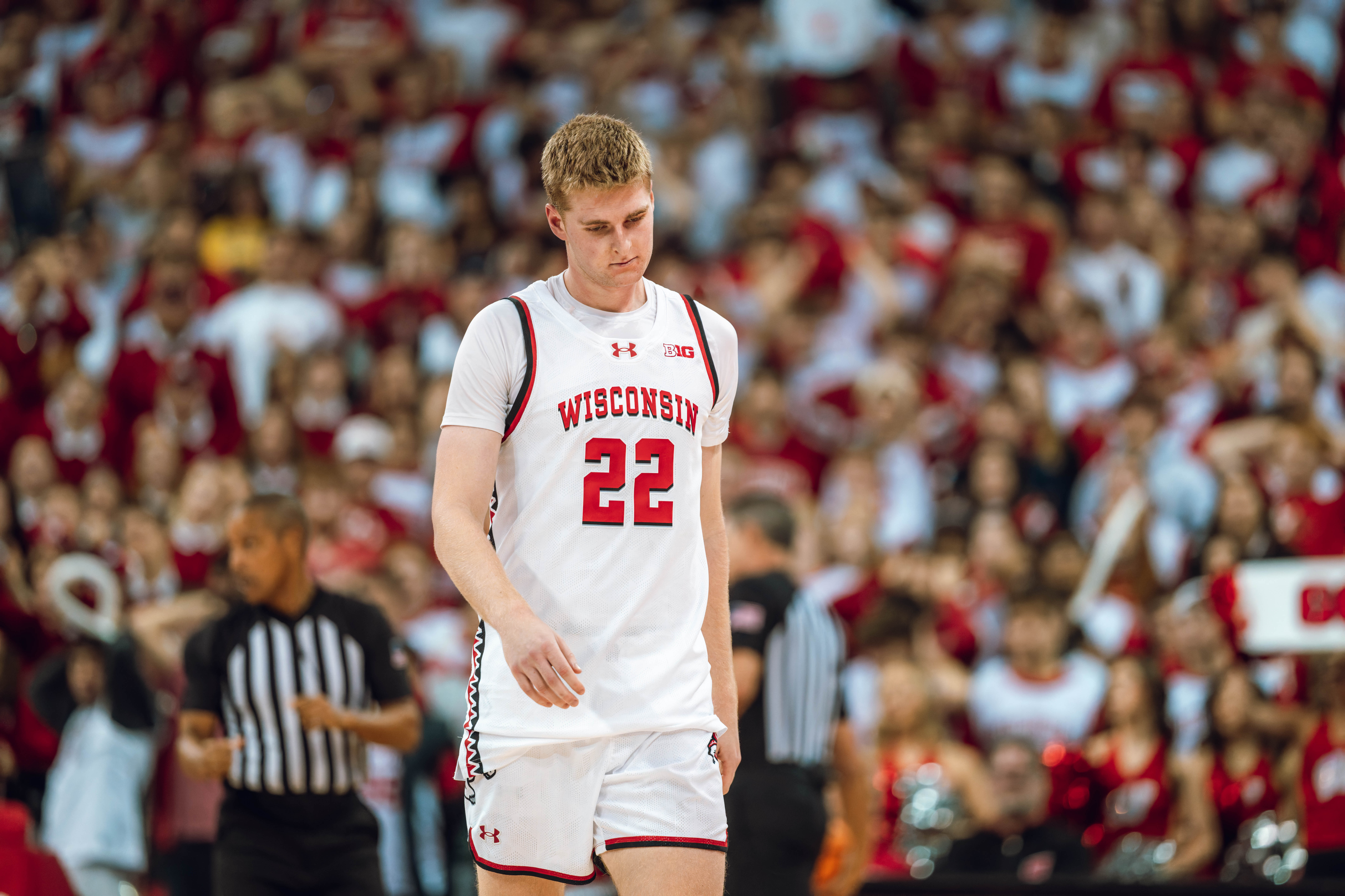 Wisconsin Badgers forward Steven Crowl #22 hangs his head after fouling out against the Michigan Wolverines at the Kohl Center on December 03, 2024 in Madison, Wisconsin. Photography by Ross Harried for Second Crop Sports.