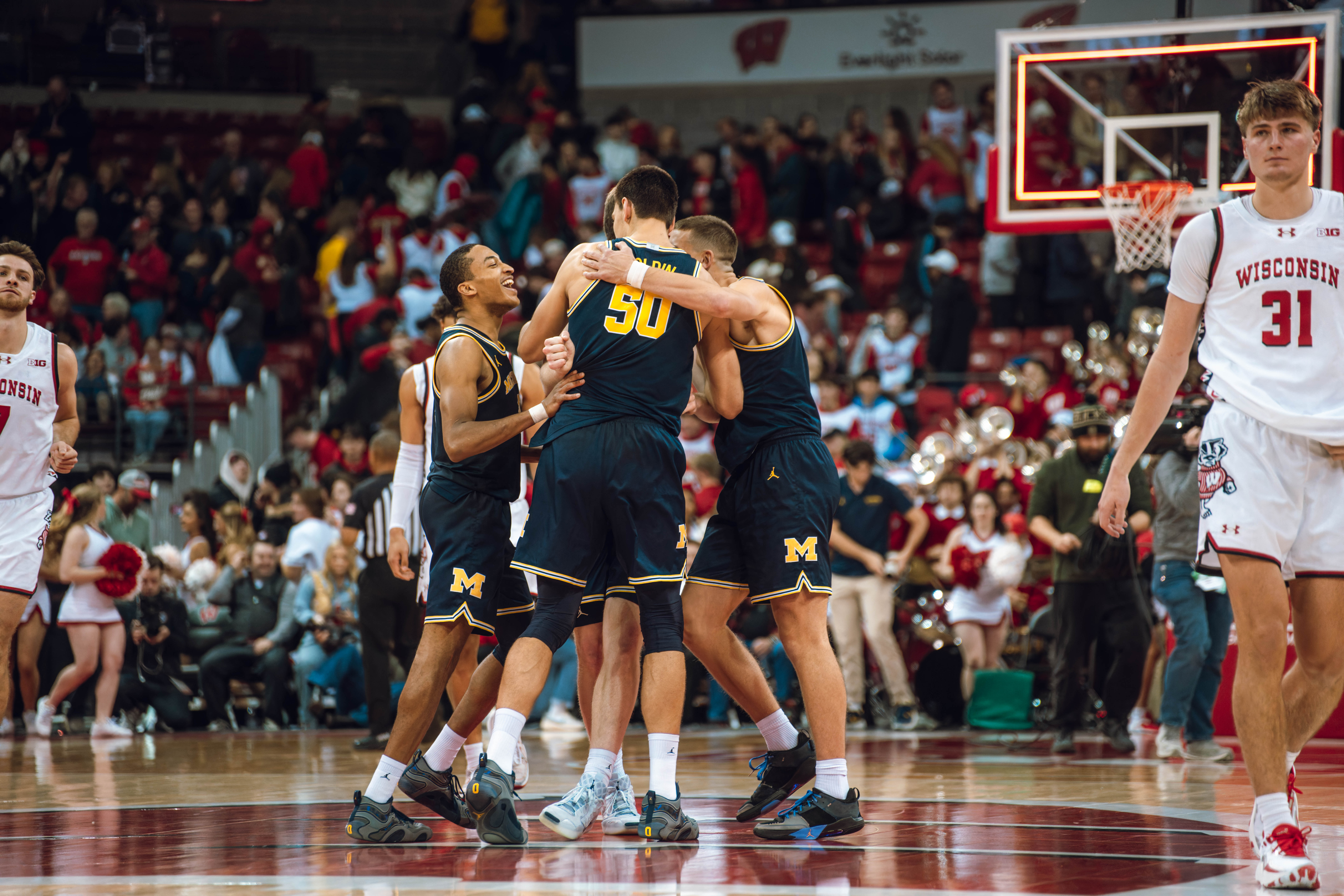 The Michigan Wolverines celebrate a win against the Wisconsin Badgers at the Kohl Center on December 03, 2024 in Madison, Wisconsin. Photography by Ross Harried for Second Crop Sports.