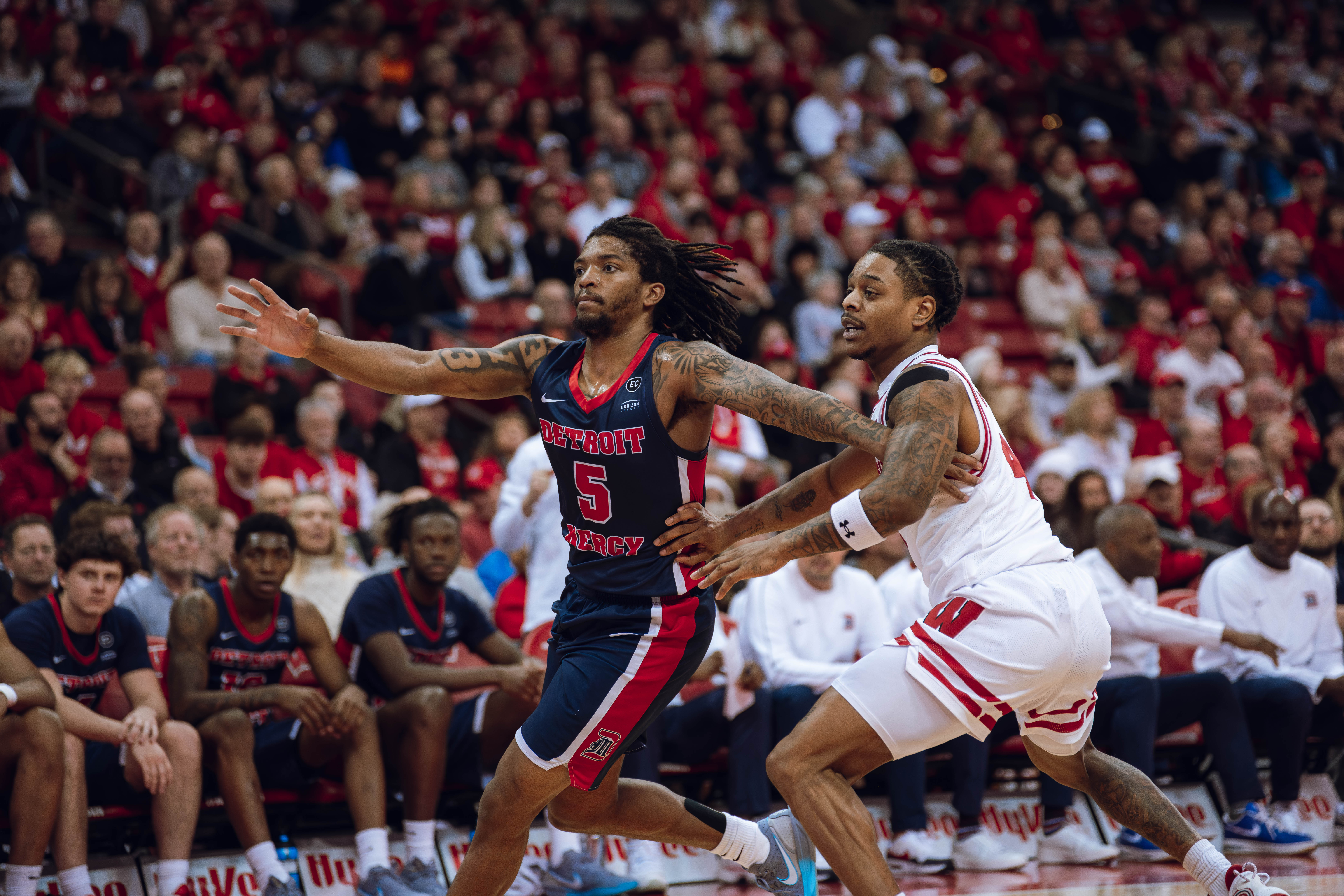 Detroit Mercy Titans guard Orlando Lovejoy #5 is defended by Wisconsin Badgers guard Kamari McGee #4 at Kohl Center on December 22, 2024 in Madison, Wisconsin. Photography by Ross Harried for Second Crop Sports.