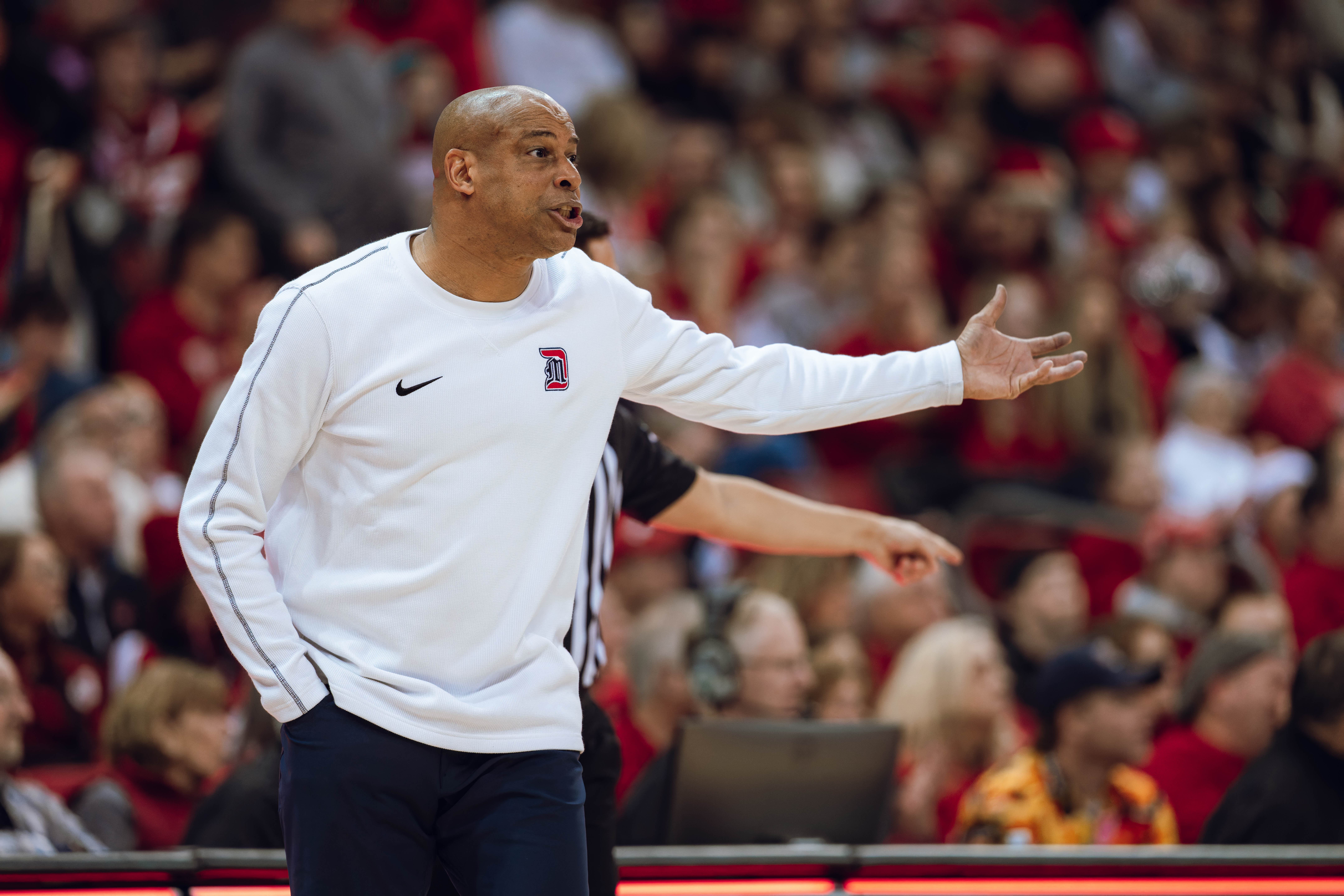 Detroit Mercy Titans head coach Mark Montgomery directs his team during the first half against the Wisconsin Badgers at Kohl Center on December 22, 2024 in Madison, Wisconsin. Photography by Ross Harried for Second Crop Sports.