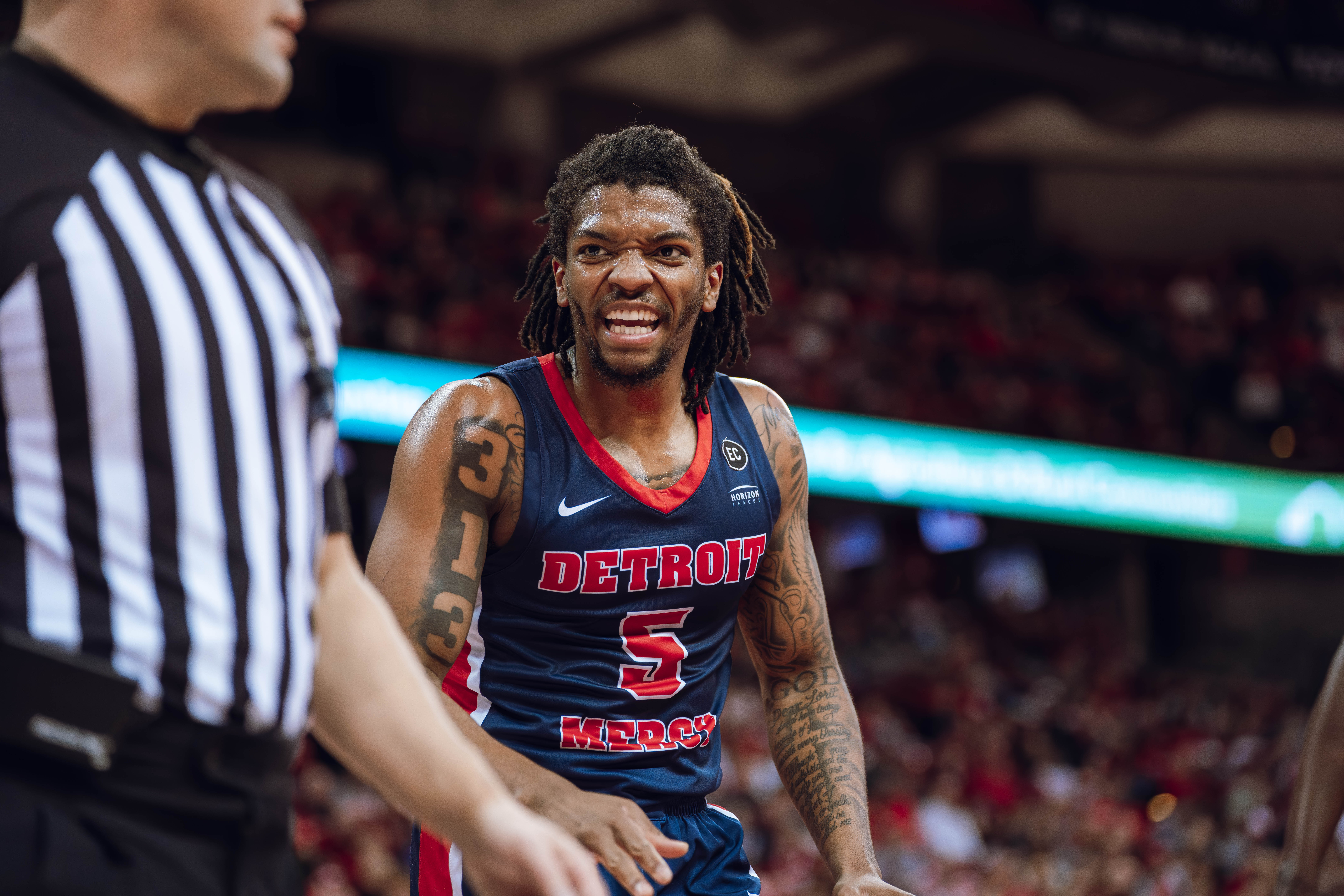 Detroit Mercy Titans guard Orlando Lovejoy #5 questions a call while playing the Wisconsin Badgers at Kohl Center on December 22, 2024 in Madison, Wisconsin. Photography by Ross Harried for Second Crop Sports.