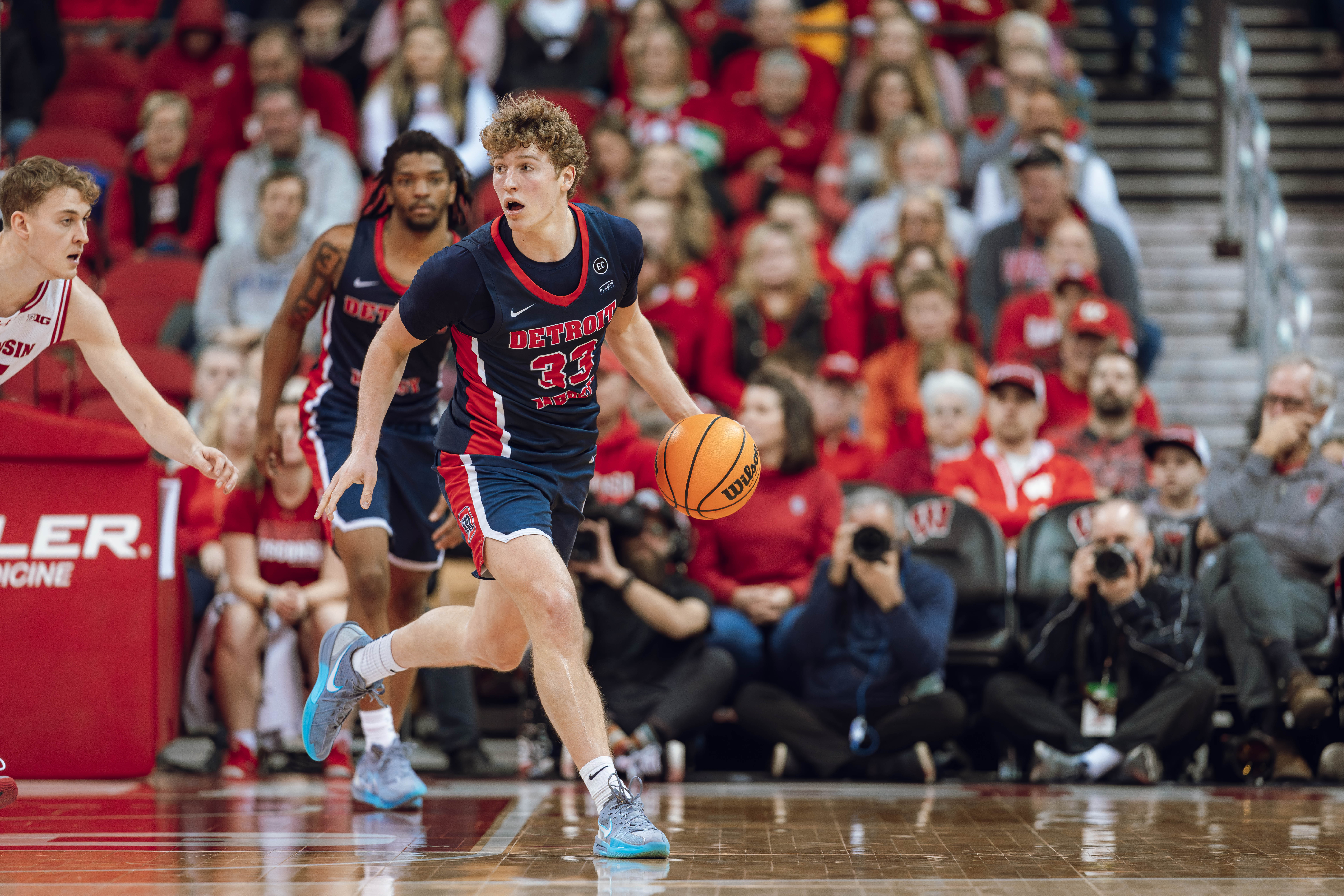 Detroit Mercy Titans guard TJ Nadeau #33 brings the ball up the court against the Wisconsin Badgers at Kohl Center on December 22, 2024 in Madison, Wisconsin. Photography by Ross Harried for Second Crop Sports.