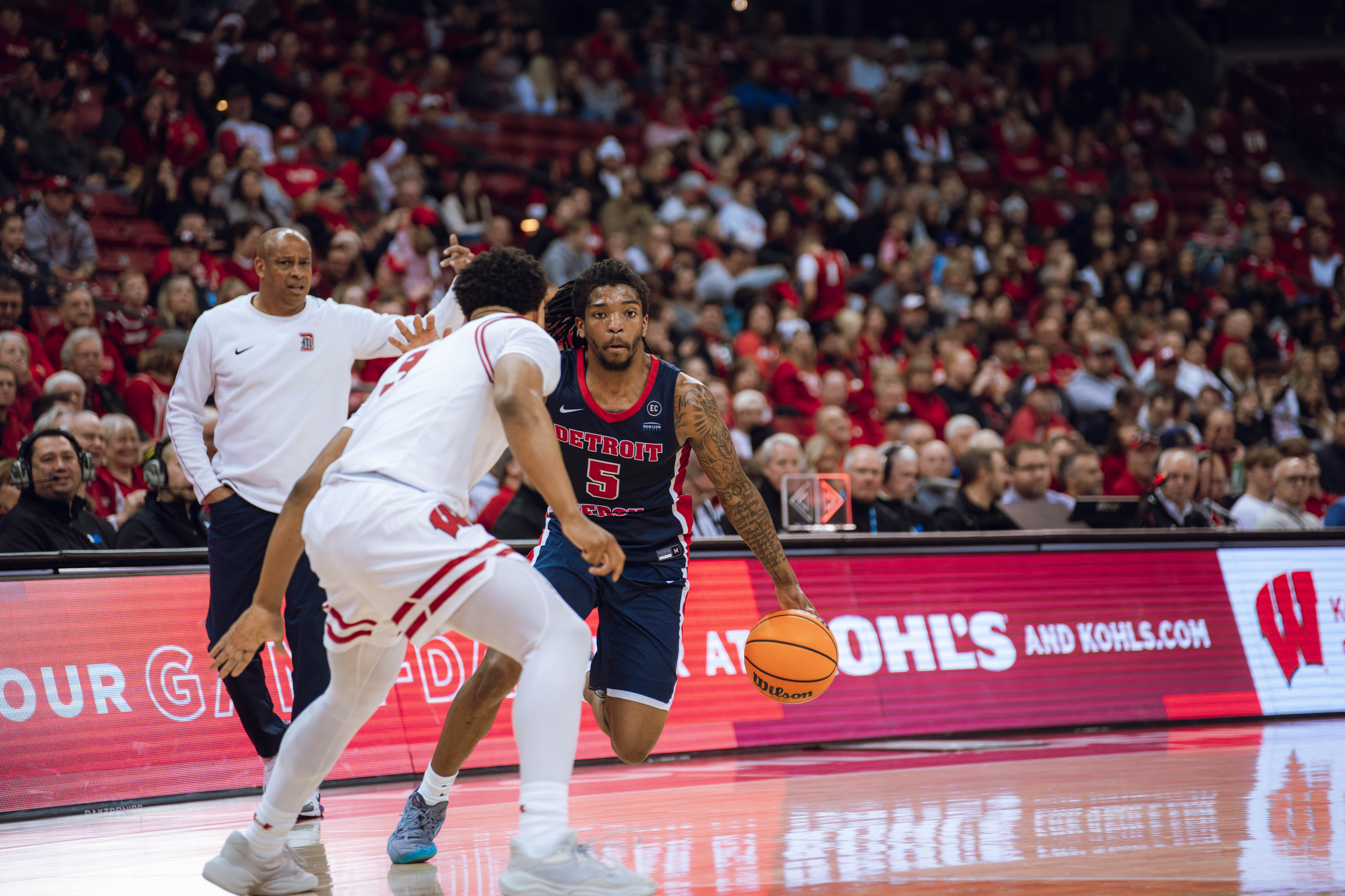 Detroit Mercy Titans guard Orlando Lovejoy #5 drives to the hoop against the Wisconsin Badgers at Kohl Center on December 22, 2024 in Madison, Wisconsin. Photography by Ross Harried for Second Crop Sports.