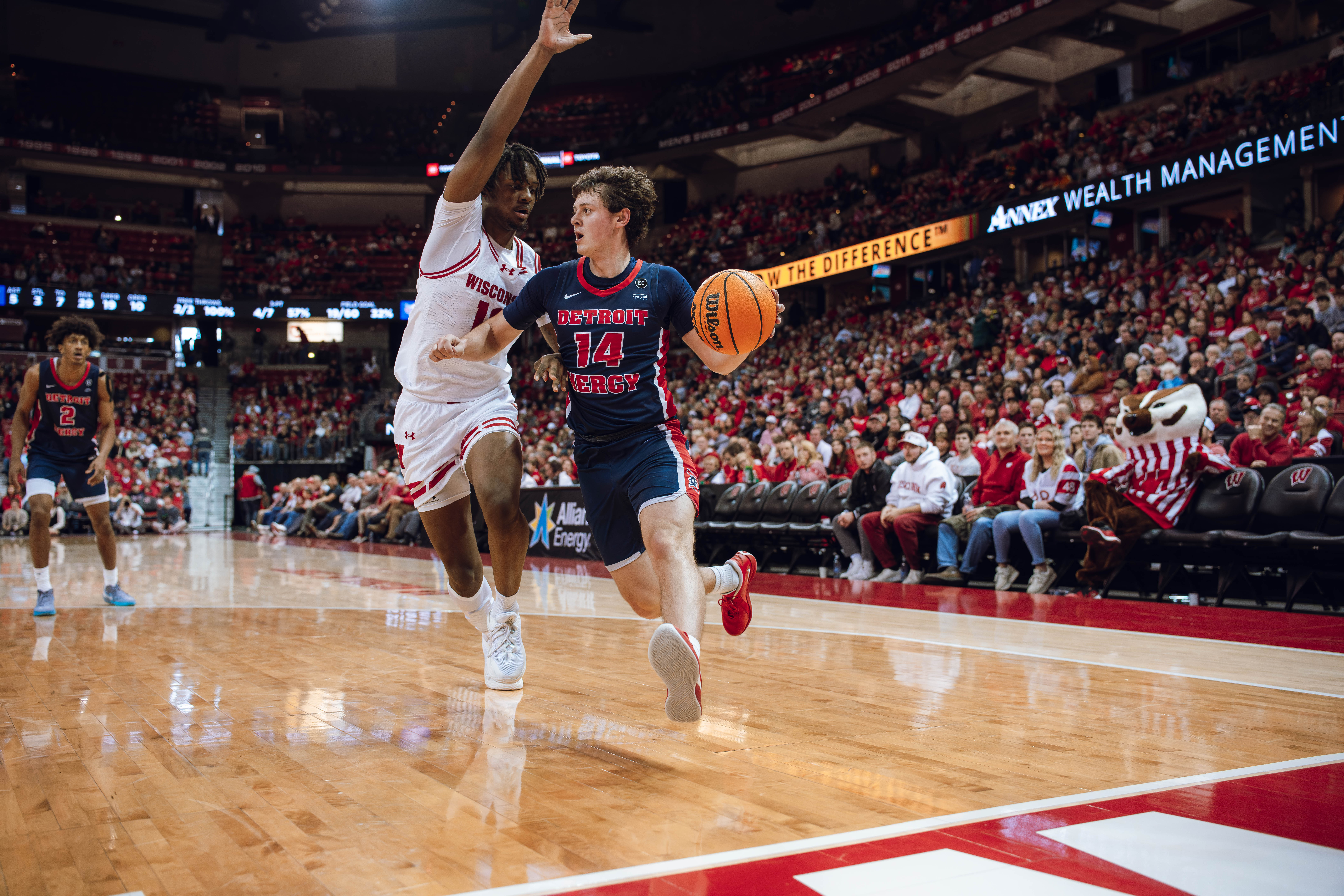 Detroit Mercy Titans guard Peter Fuchs Jr. #14 drive the baseline against the Wisconsin Badgers at Kohl Center on December 22, 2024 in Madison, Wisconsin. Photography by Ross Harried for Second Crop Sports.