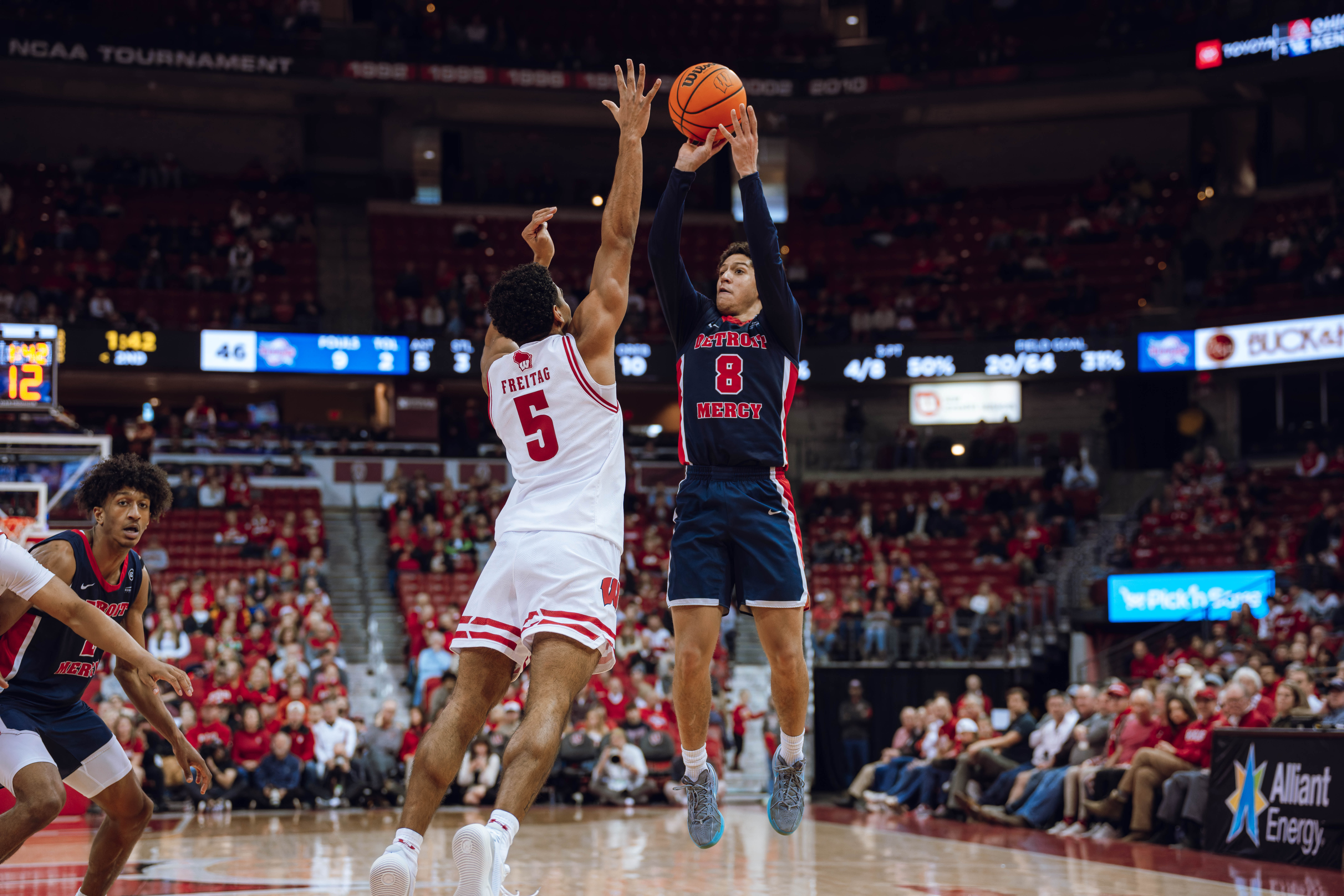 Detroit Mercy Titans guard Grant Gondrezick II #8 shoots over Wisconsin Badgers guard Daniel Freitag #5 at Kohl Center on December 22, 2024 in Madison, Wisconsin. Photography by Ross Harried for Second Crop Sports.