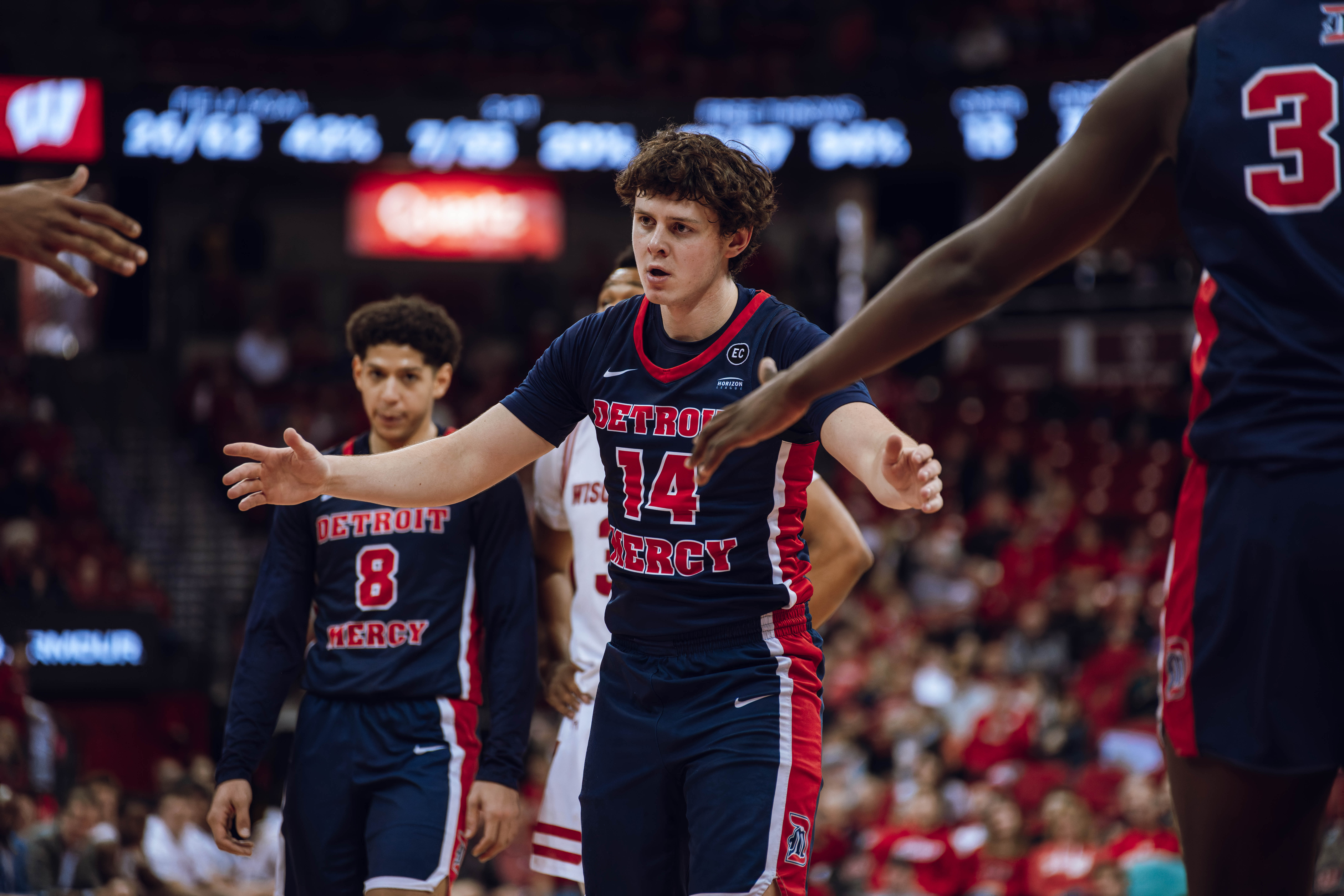 Detroit Mercy Titans guard Peter Fuchs Jr. #14 celebrates a free throw with his team against the Wisconsin Badgers at Kohl Center on December 22, 2024 in Madison, Wisconsin. Photography by Ross Harried for Second Crop Sports.