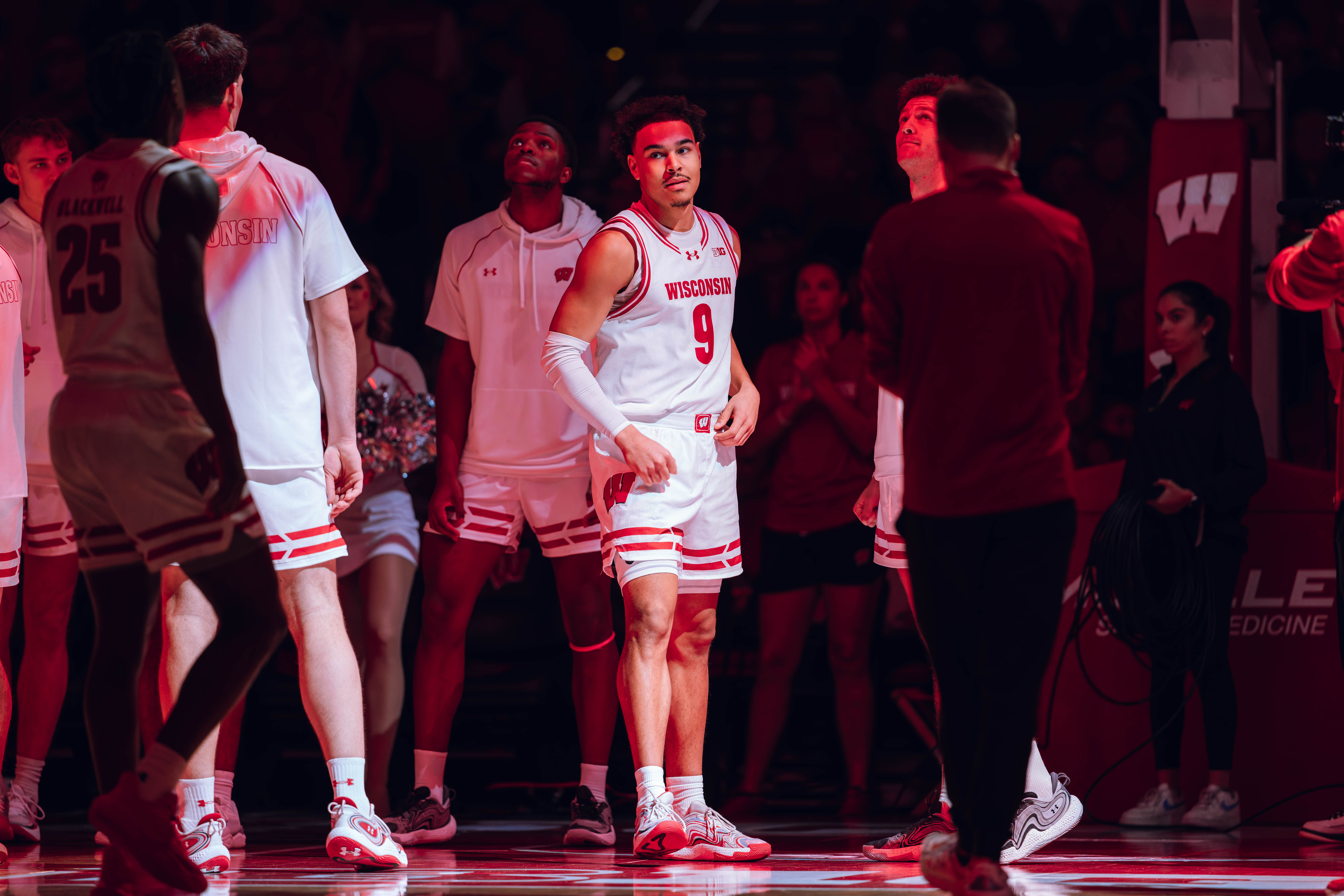 Wisconsin Badgers guard John Tonje #9 greets his team during starting lineups against the Detroit Mercy Titans at Kohl Center on December 22, 2024 in Madison, Wisconsin. Photography by Ross Harried for Second Crop Sports.