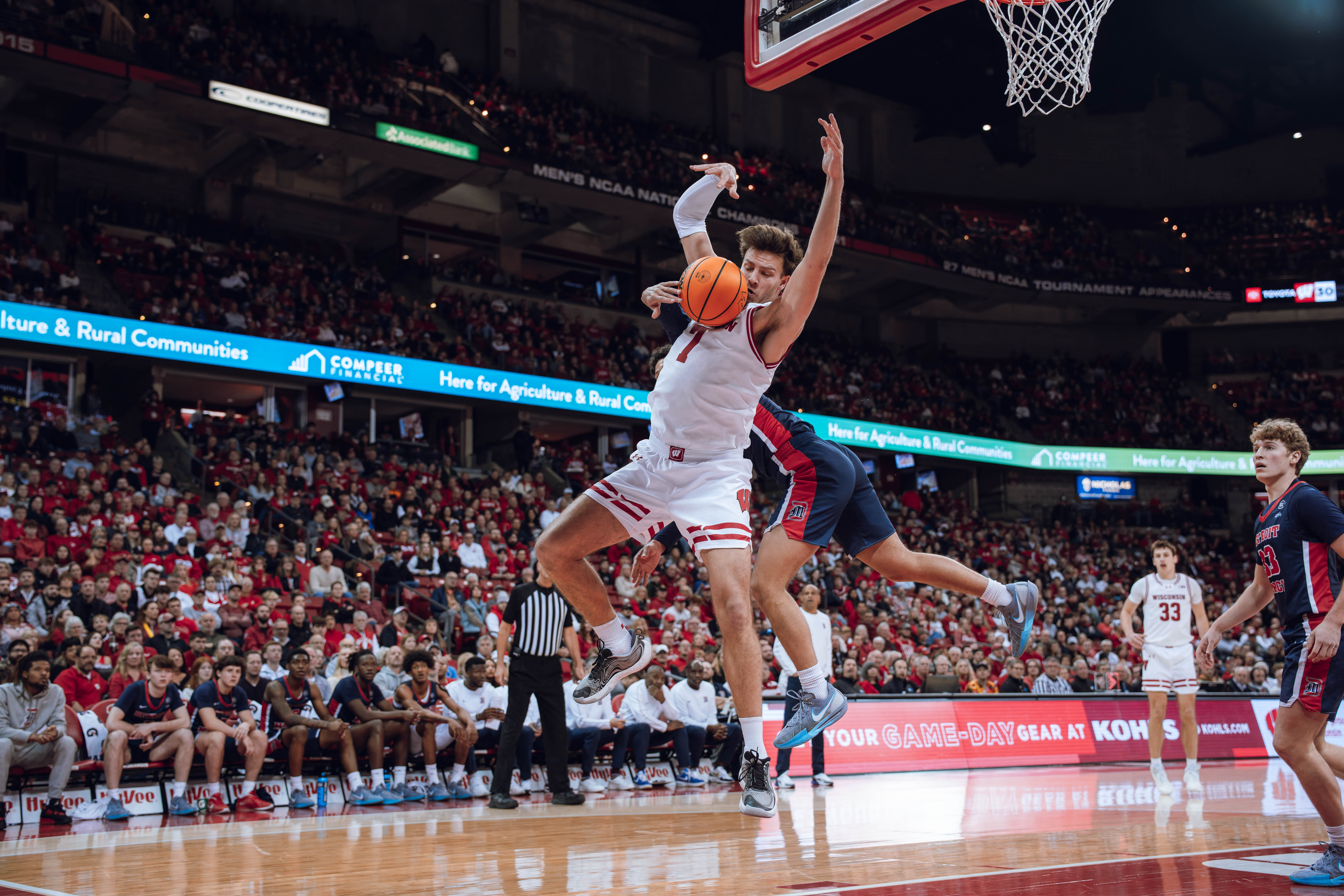 Wisconsin Badgers forward Carter Gilmore #7 attempts to haul in a rebound against the Detroit Mercy Titans at Kohl Center on December 22, 2024 in Madison, Wisconsin. Photography by Ross Harried for Second Crop Sports.