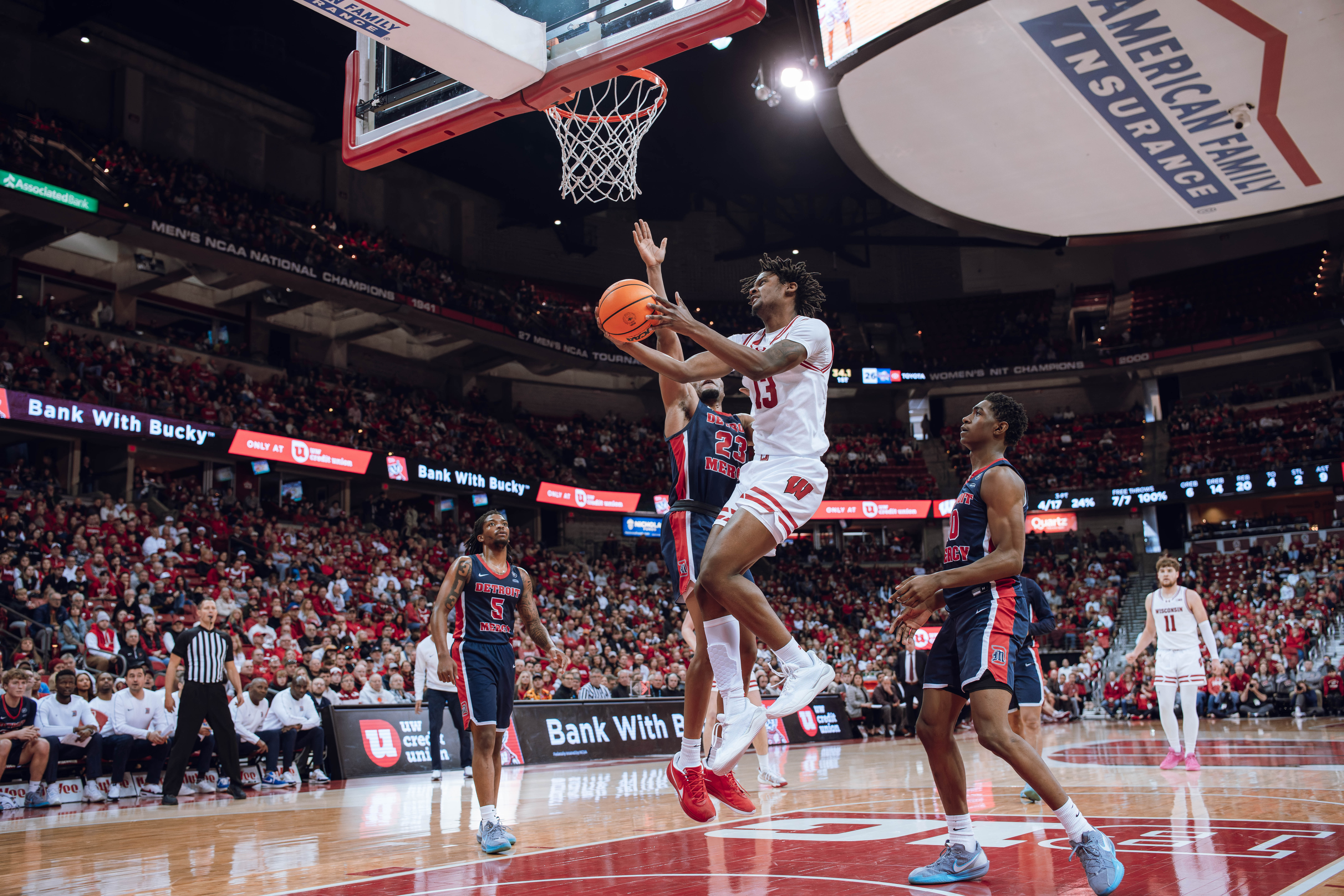 Wisconsin Badgers forward Xavier Amos #13 drives the lane for the reverse layup against the Detroit Mercy Titans at Kohl Center on December 22, 2024 in Madison, Wisconsin. Photography by Ross Harried for Second Crop Sports.