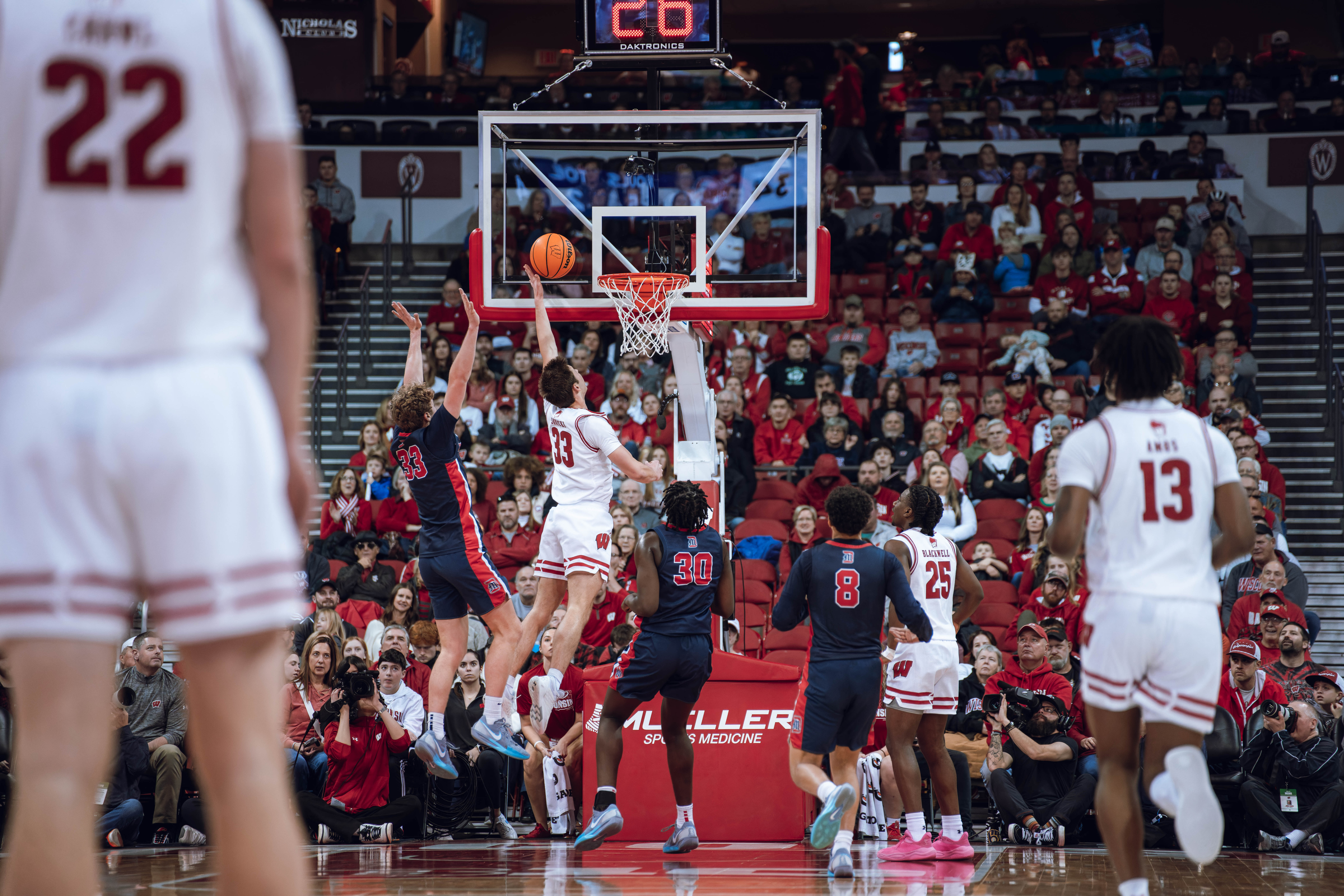 Wisconsin Badgers guard Jack Janicki #33 attempts a layup against the Detroit Mercy Titans at Kohl Center on December 22, 2024 in Madison, Wisconsin. Photography by Ross Harried for Second Crop Sports.