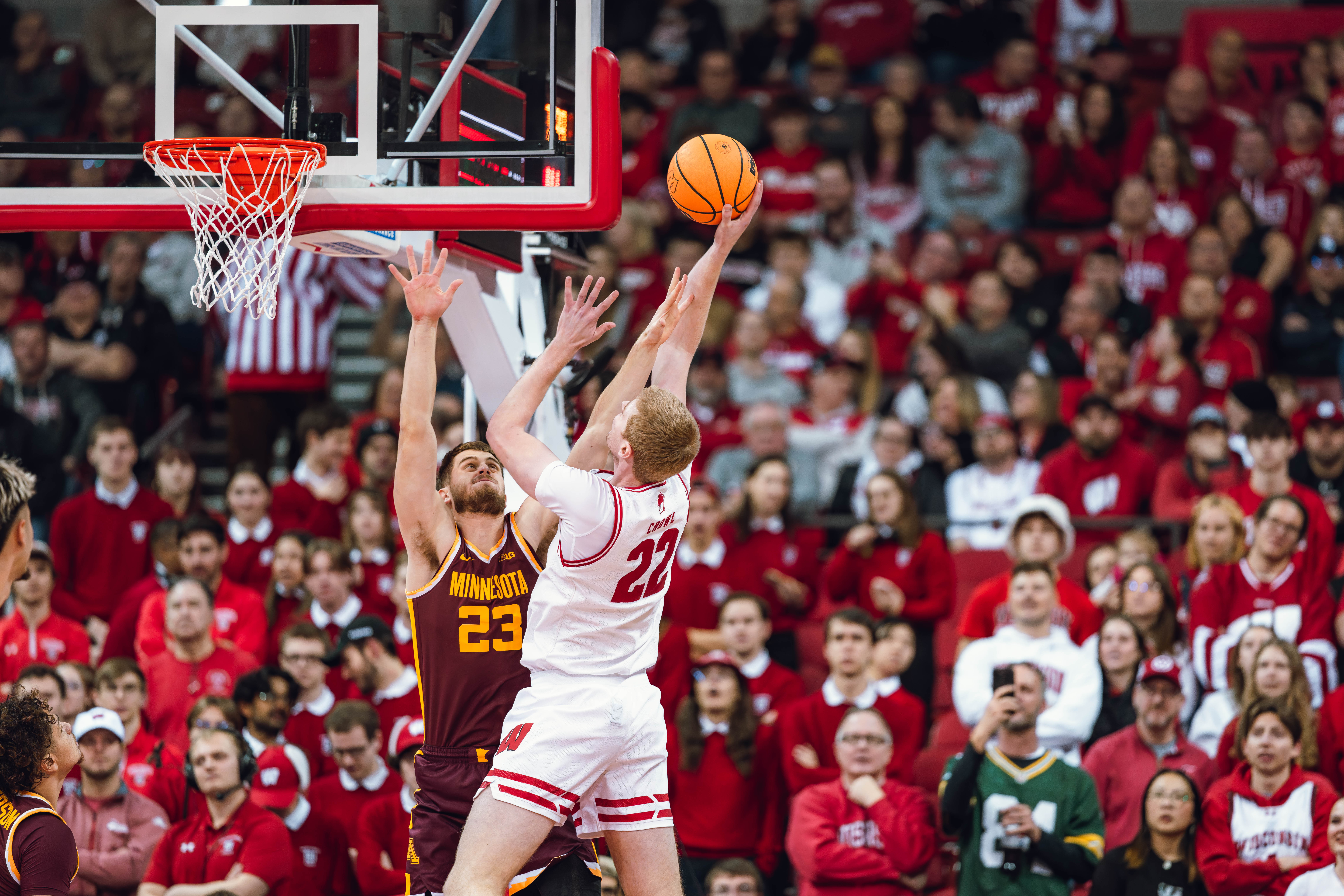 Wisconsin Badgers forward Steven Crowl #22 attempts a shot against Minnesota Golden Gophers forward Parker Fox #23 at Kohl Center on January 10, 2025 in Madison, Wisconsin. Photography by Ross Harried for Second Crop Sports.