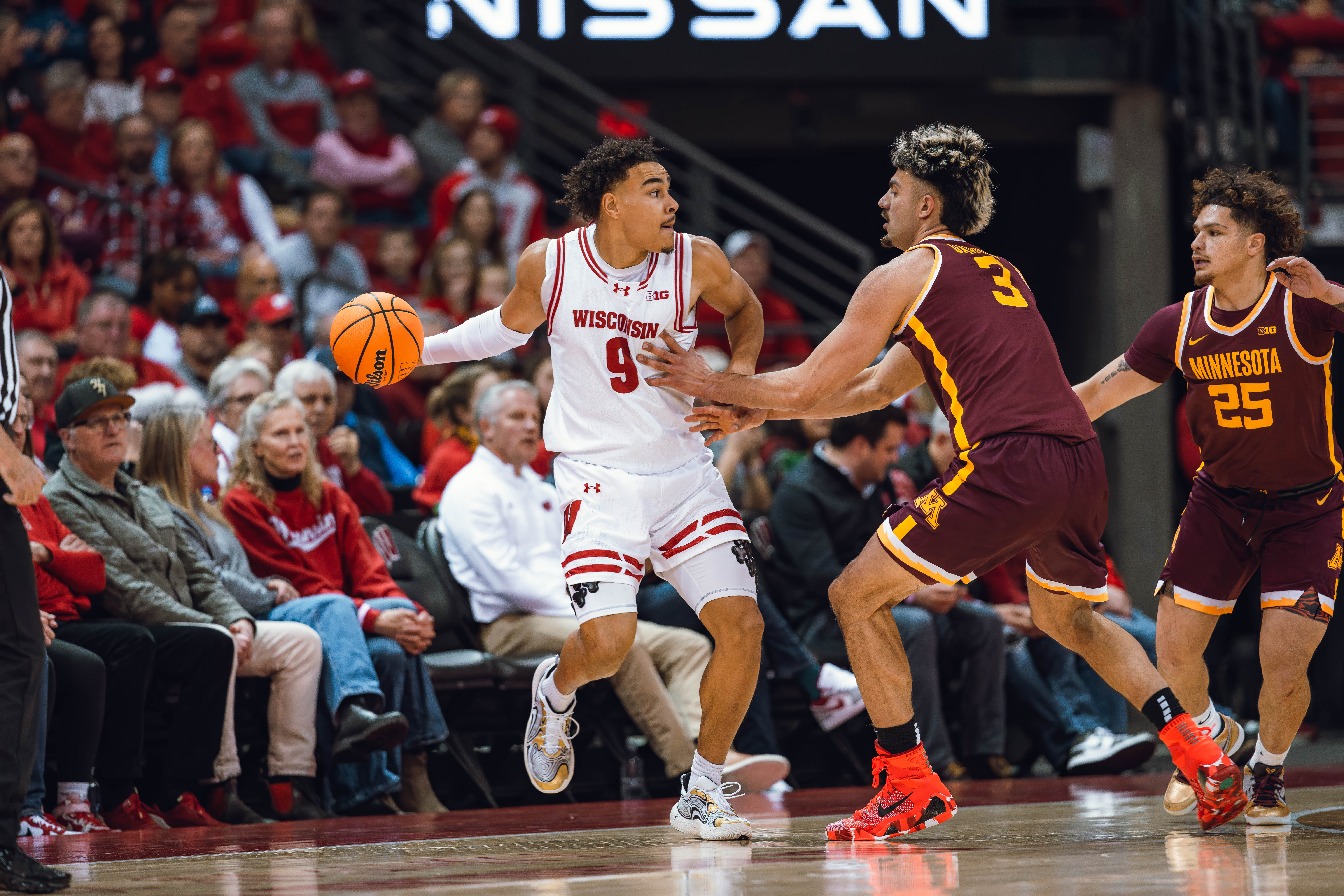 Wisconsin Badgers guard John Tonje #9 looks to pass while defended by Minnesota Golden Gophers forward Dawson Garcia #3 at Kohl Center on January 10, 2025 in Madison, Wisconsin. Photography by Ross Harried for Second Crop Sports.