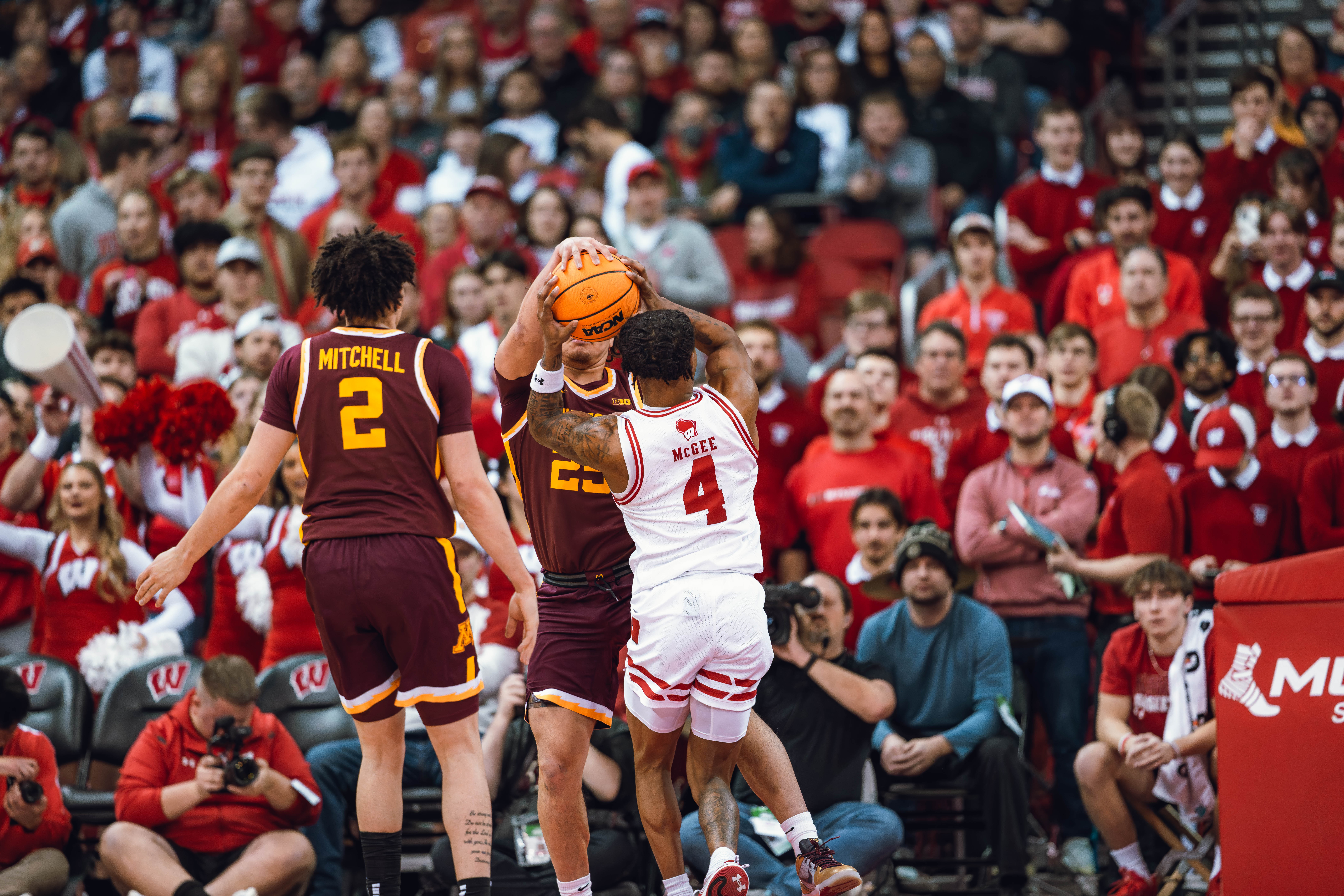 Wisconsin Badgers guard Kamari McGee #4 gets tied up by Minnesota Golden Gophers guard Lu'Cye Patterson #25 for a jump ball at Kohl Center on January 10, 2025 in Madison, Wisconsin. Photography by Ross Harried for Second Crop Sports.