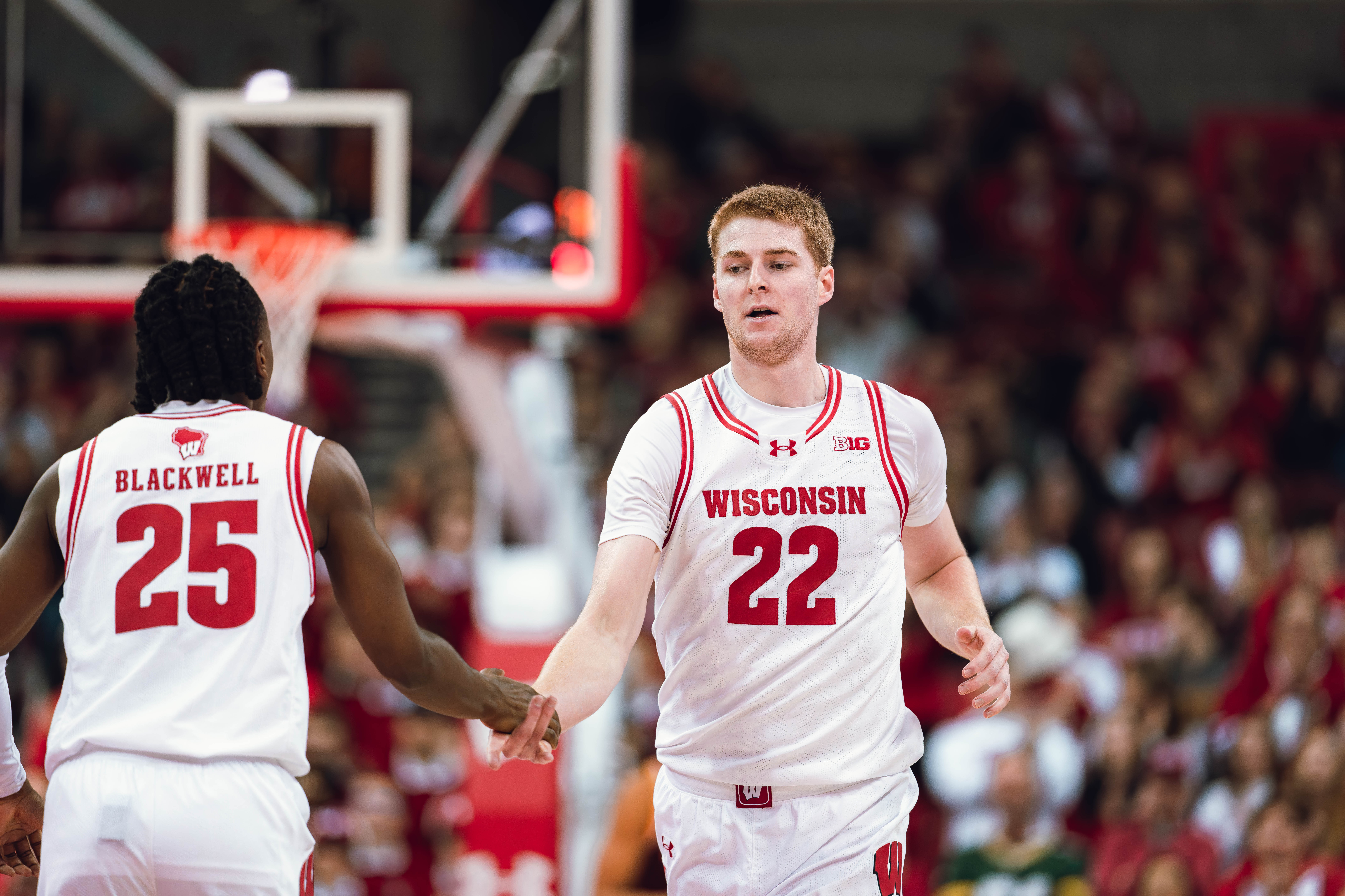 Wisconsin Badgers forward Steven Crowl #22 celebrates with guard John Blackwell #25 against the Minnesota Golden Gophers at Kohl Center on January 10, 2025 in Madison, Wisconsin. Photography by Ross Harried for Second Crop Sports.