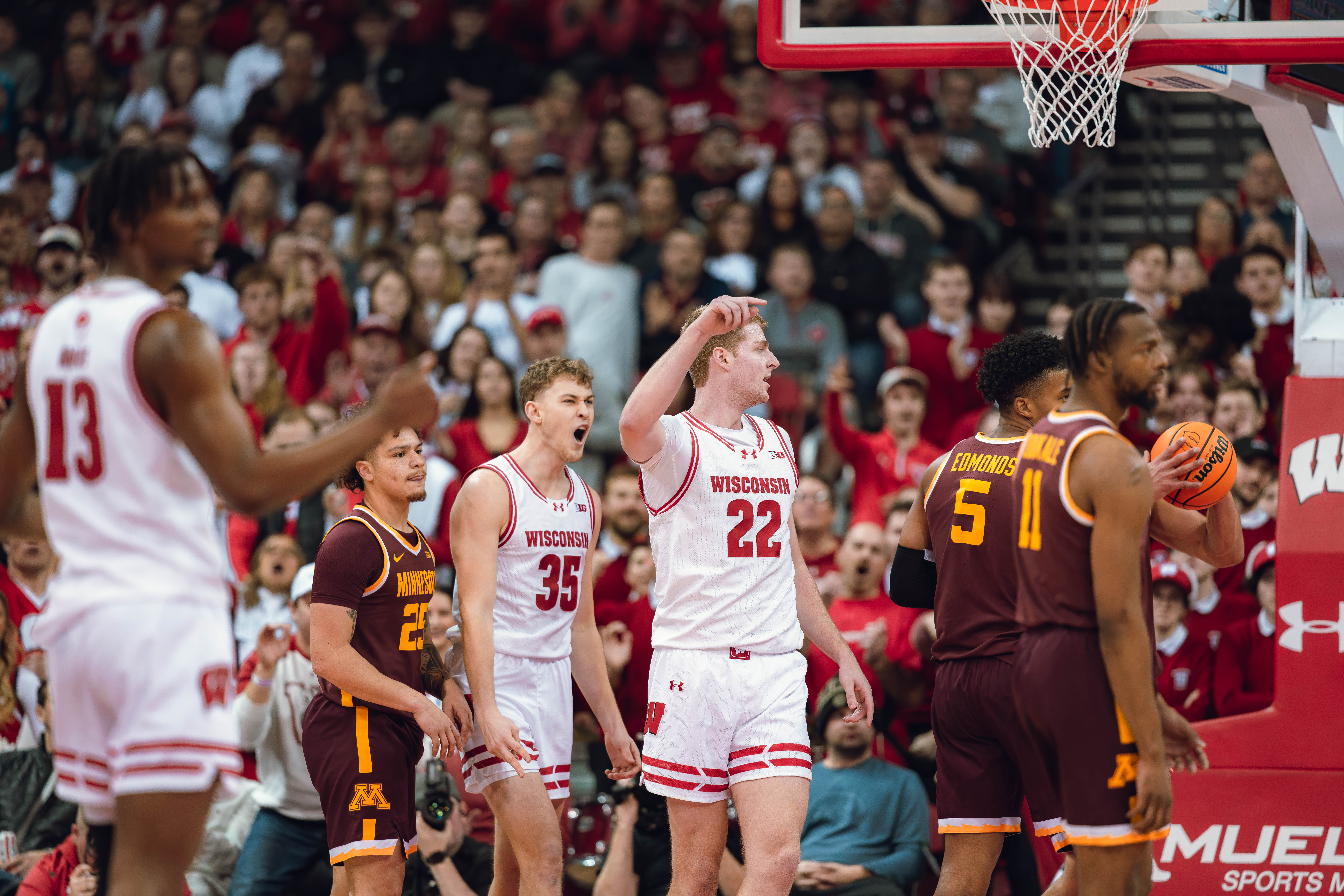 Wisconsin Badgers forward Markus Ilver #35 celebrates a Steven Crowl #22 and one against the Minnesota Golden Gophers at Kohl Center on January 10, 2025 in Madison, Wisconsin. Photography by Ross Harried for Second Crop Sports.