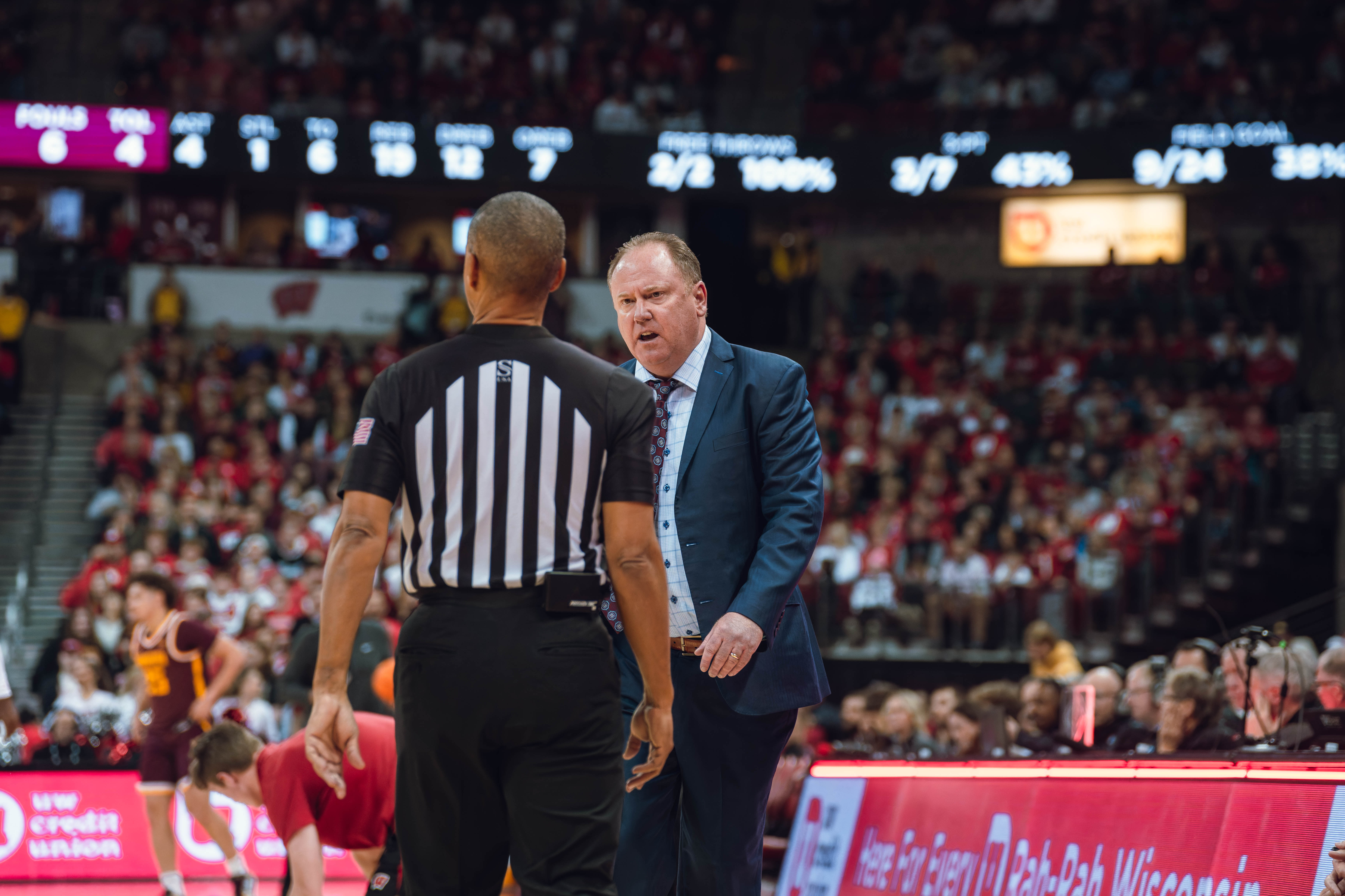 Wisconsin Badgers Head Coach Greg Gard talks to the referee during a matchup against the Minnesota Golden Gophers at Kohl Center on January 10, 2025 in Madison, Wisconsin. Photography by Ross Harried for Second Crop Sports.