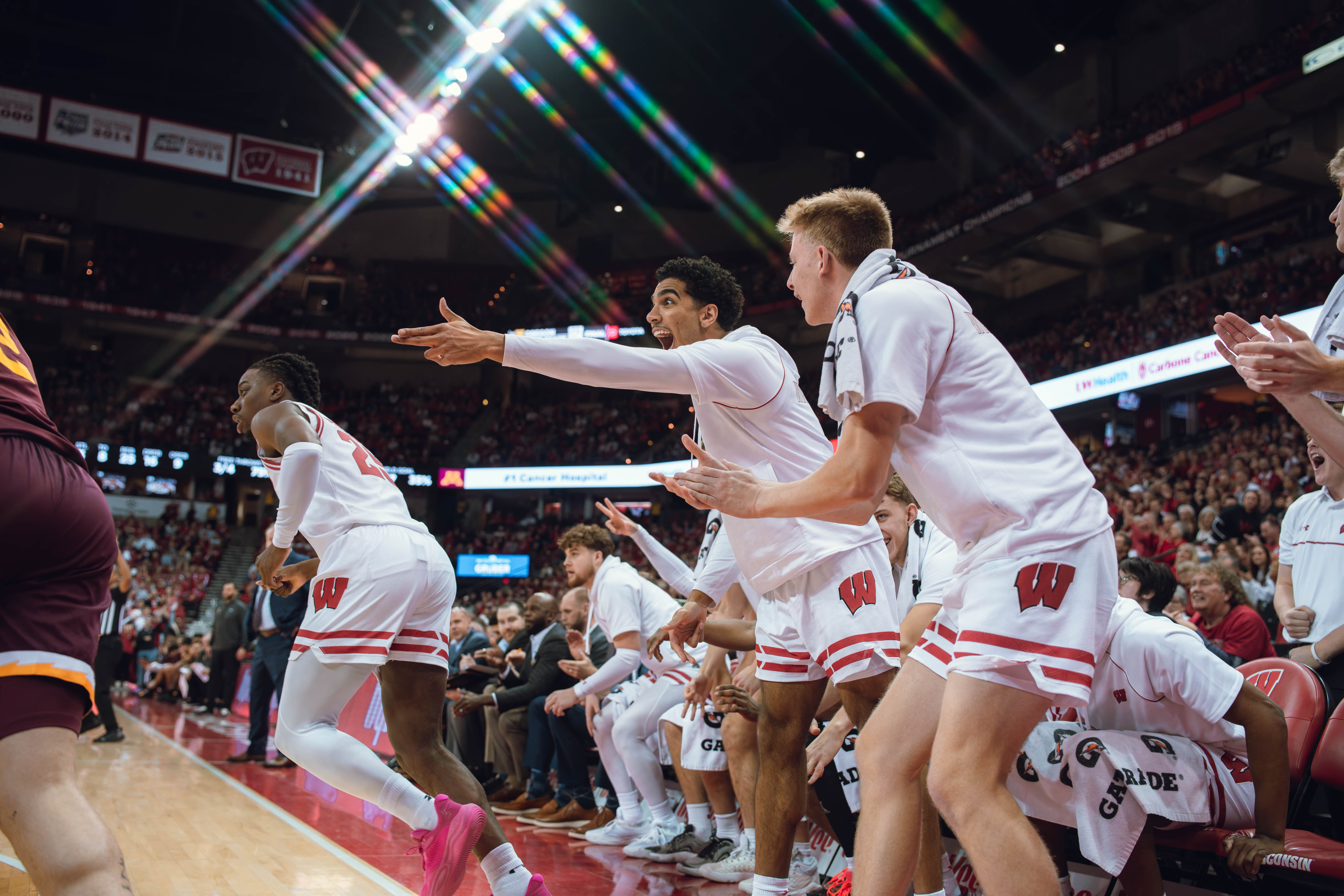 The Wisconsin Badgers bench celebrates a Wisconsin Badgers guard John Blackwell #25 against the Minnesota Golden Gophers at Kohl Center on January 10, 2025 in Madison, Wisconsin. Photography by Ross Harried for Second Crop Sports.