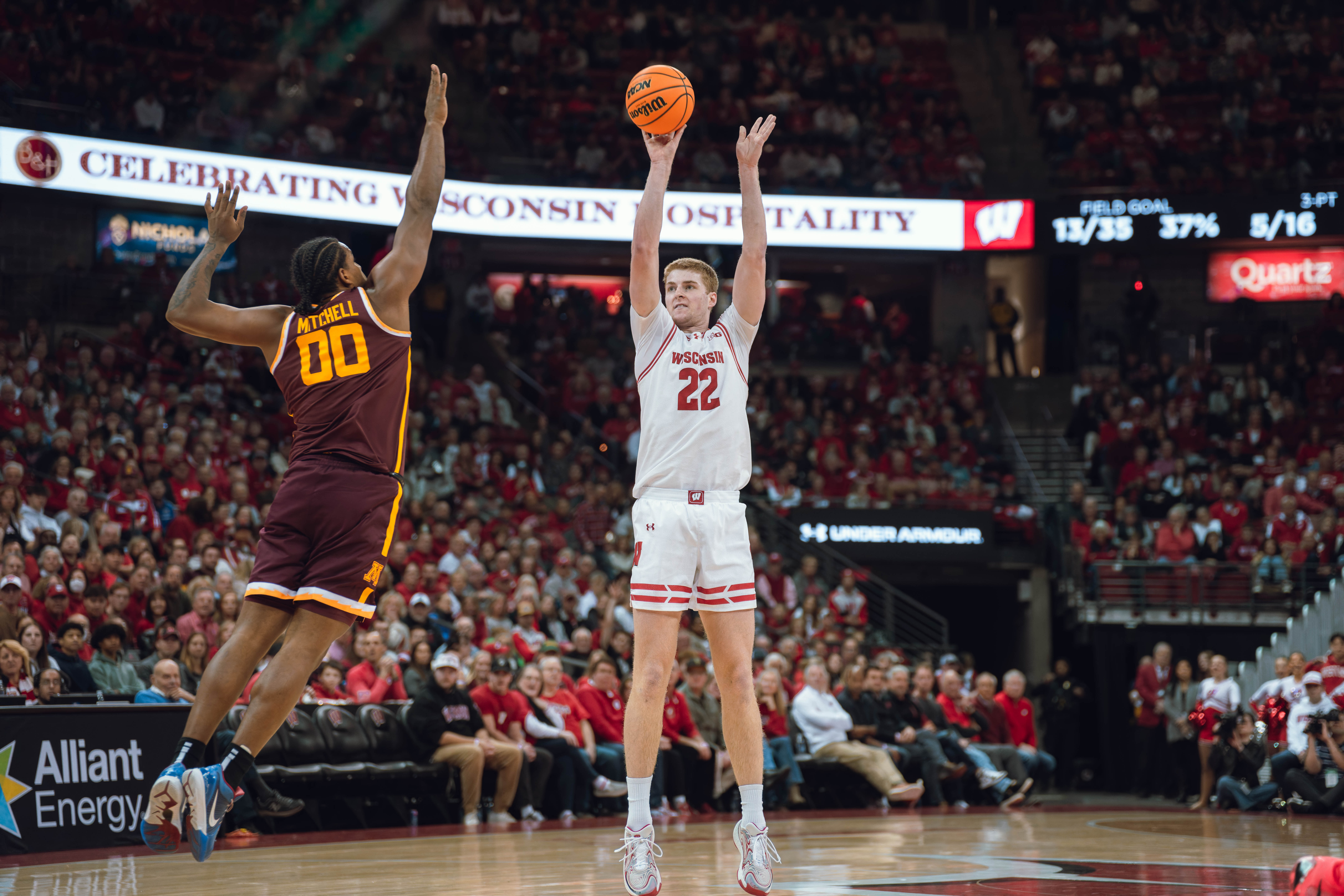 Wisconsin Badgers forward Steven Crowl #22 drains a three while defended by Minnesota Golden Gophers forward Frank Mitchell #00 at Kohl Center on January 10, 2025 in Madison, Wisconsin. Photography by Ross Harried for Second Crop Sports.