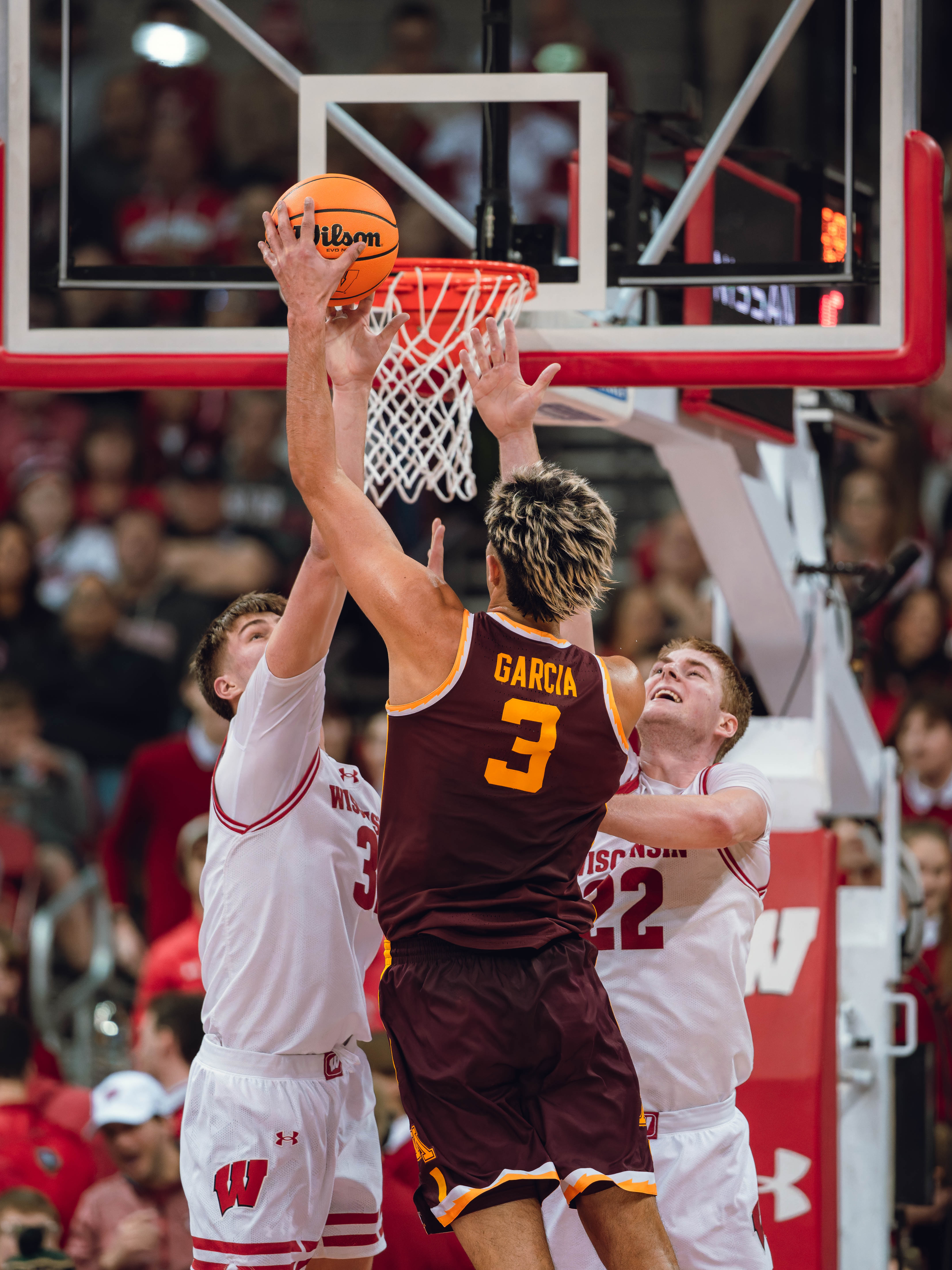 Minnesota Golden Gophers forward Dawson Garcia #3 is defended by Wisconsin Badgers forward Nolan Winter #31 & forward Steven Crowl #22 at Kohl Center on January 10, 2025 in Madison, Wisconsin. Photography by Ross Harried for Second Crop Sports.