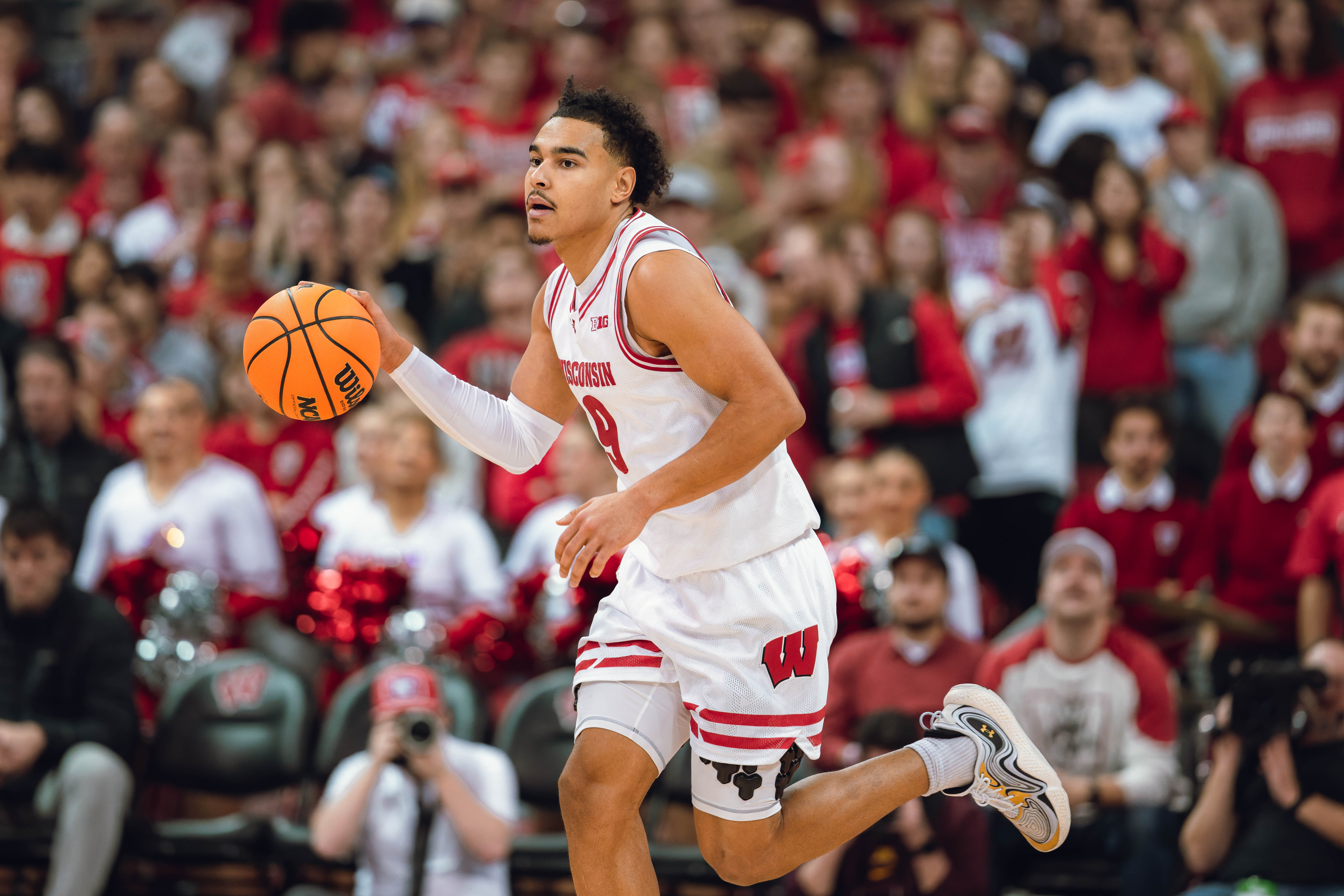 Wisconsin Badgers guard John Tonje #9 brings the ball up the court against the Minnesota Golden Gophers at Kohl Center on January 10, 2025 in Madison, Wisconsin. Photography by Ross Harried for Second Crop Sports.