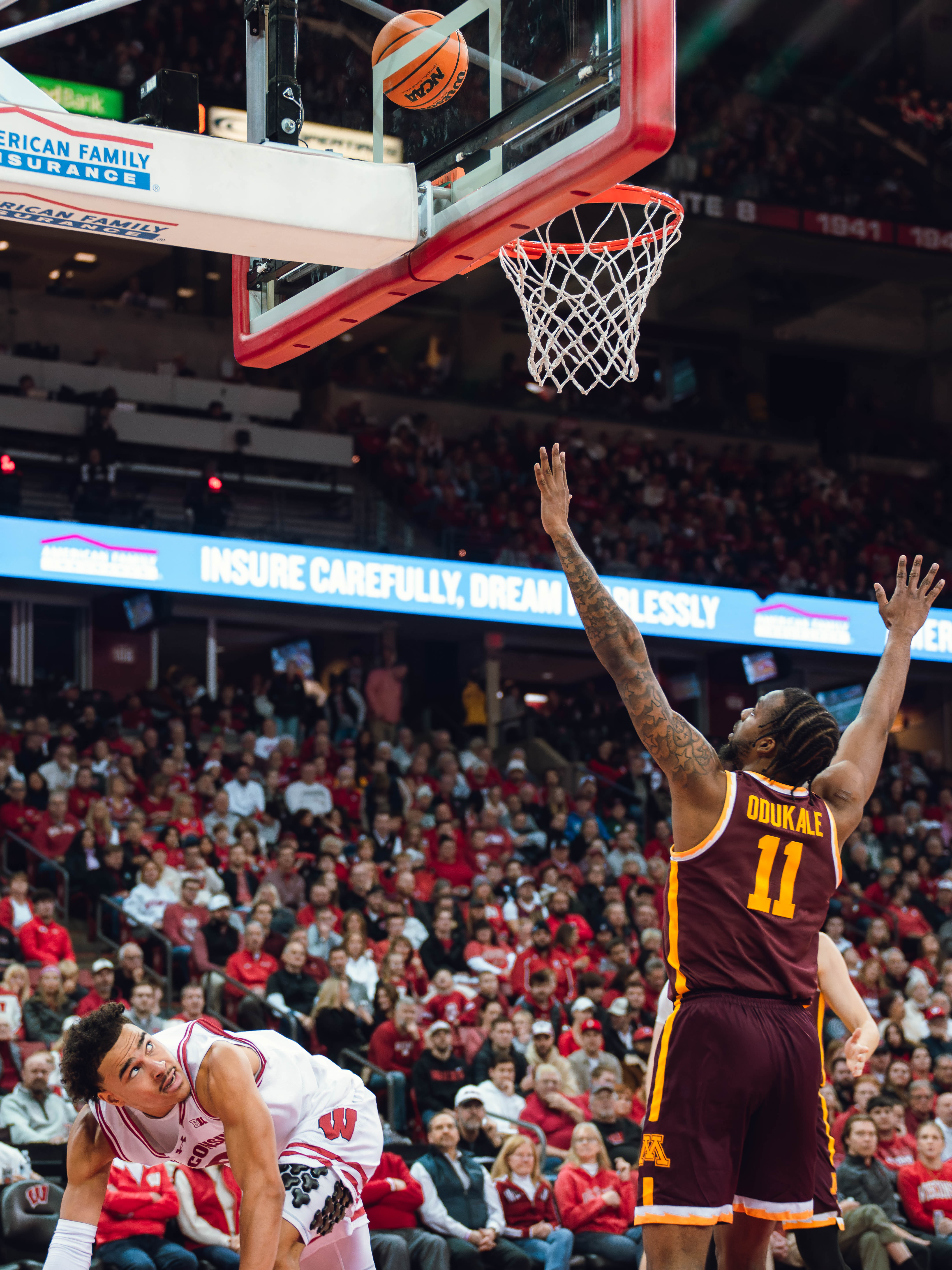 Wisconsin Badgers guard John Tonje #9 eyes his layup as he is fouled by Minnesota Golden Gophers guard Femi Odukale #11 at Kohl Center on January 10, 2025 in Madison, Wisconsin. Photography by Ross Harried for Second Crop Sports.