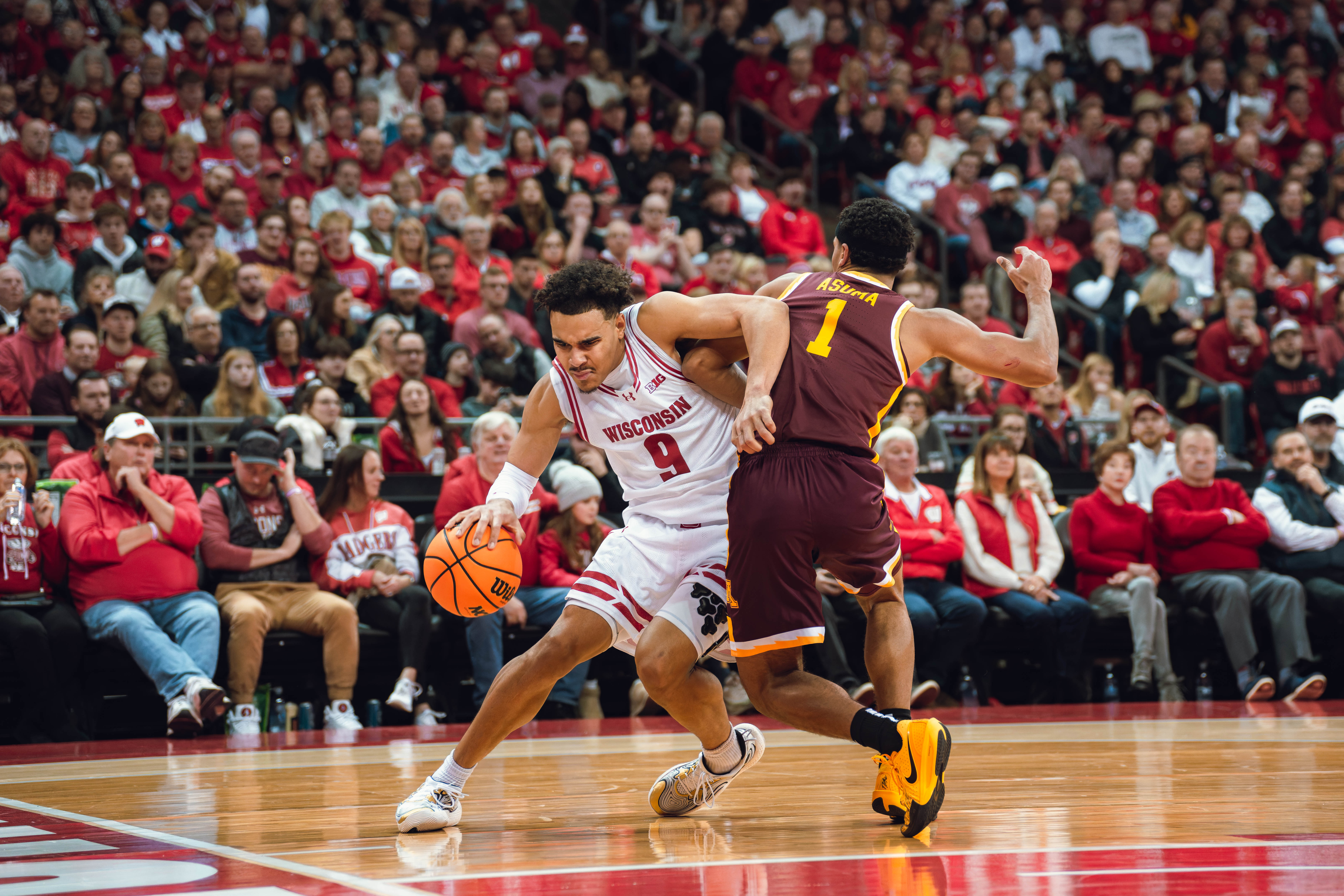 Wisconsin Badgers guard John Tonje #9 drives the baseline defended by Minnesota Golden Gophers guard Isaac Asuma #1 Kohl Center on January 10, 2025 in Madison, Wisconsin. Photography by Ross Harried for Second Crop Sports.