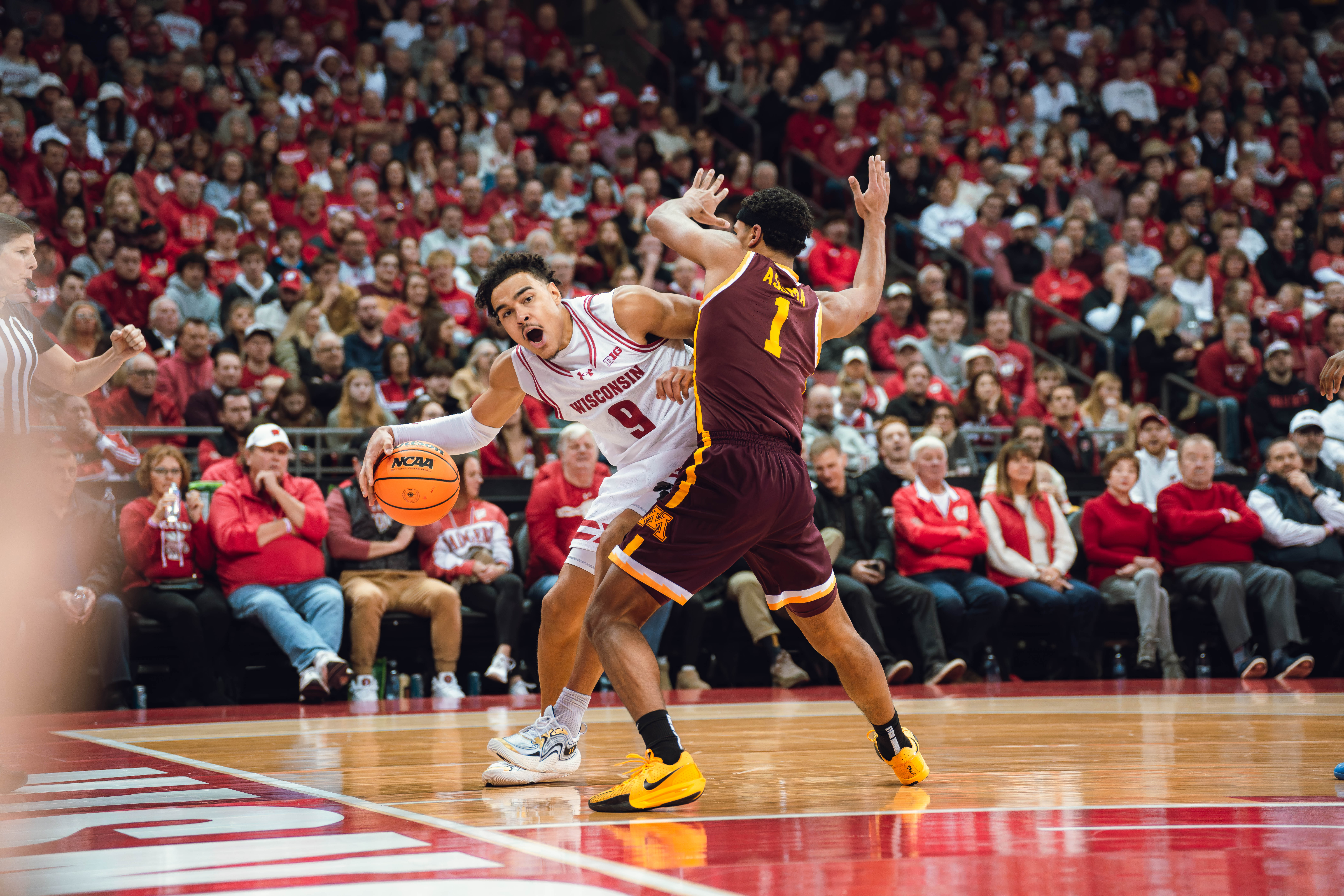 Wisconsin Badgers guard John Tonje #9 drives the baseline defended by Minnesota Golden Gophers guard Isaac Asuma #1 Kohl Center on January 10, 2025 in Madison, Wisconsin. Photography by Ross Harried for Second Crop Sports.