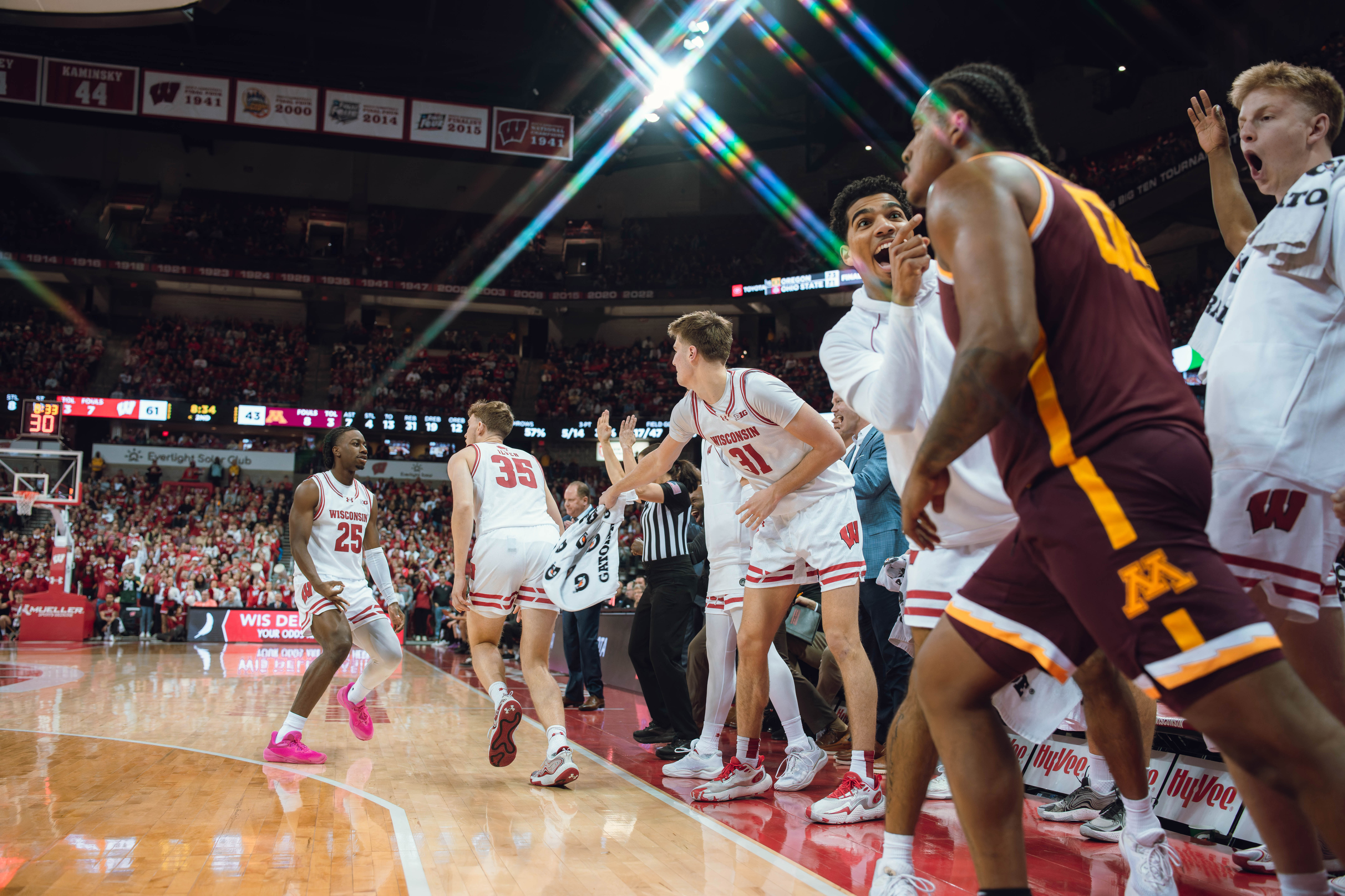 The Wisconsin Badgers bench celebrates a Wisconsin Badgers forward Markus Ilver #35 three pointer late in the game against the Minnesota Golden Gophers at Kohl Center on January 10, 2025 in Madison, Wisconsin. Photography by Ross Harried for Second Crop Sports.