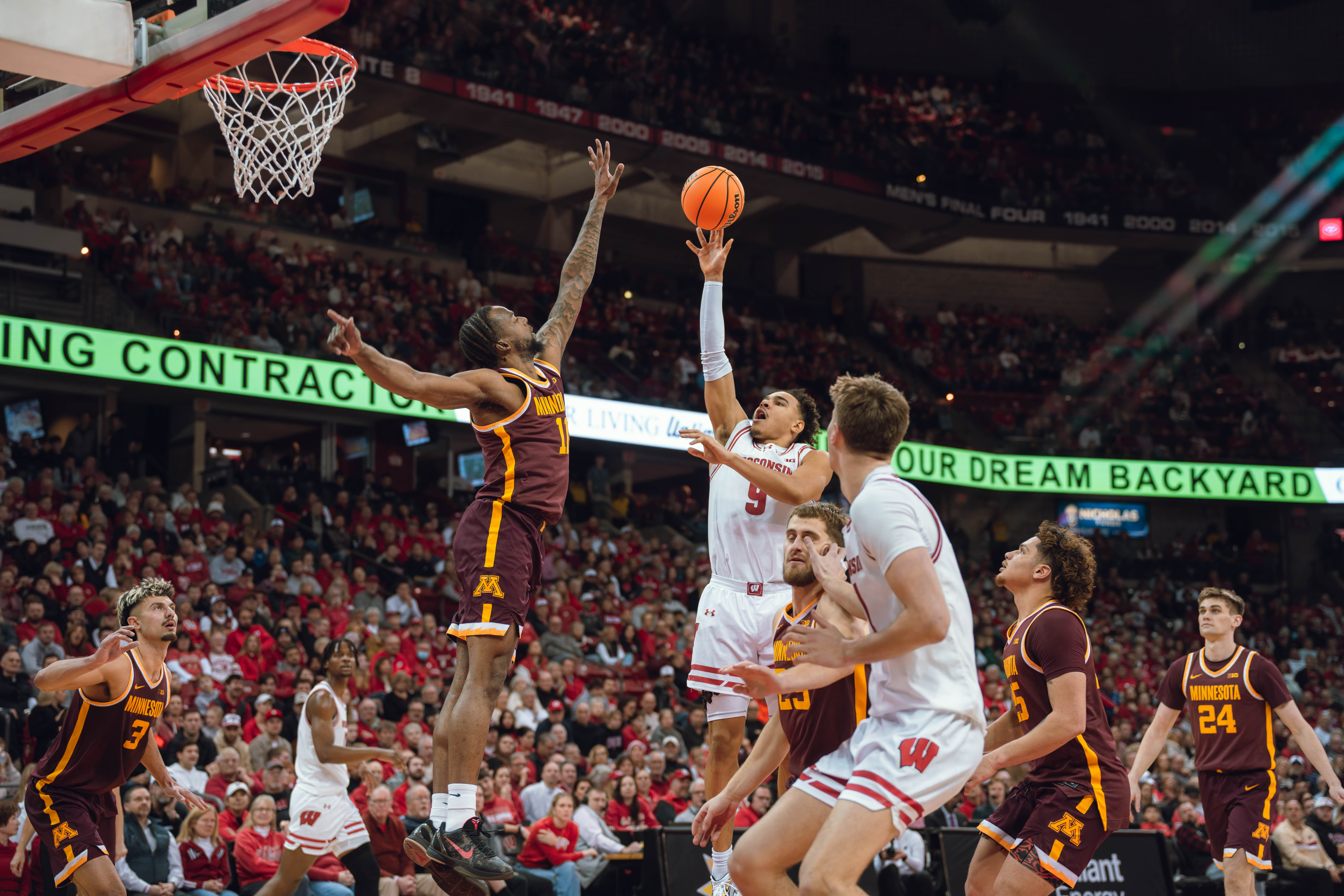 Wisconsin Badgers guard John Tonje #9 shoots over Minnesota Golden Gophers guard Femi Odukale #11 at Kohl Center on January 10, 2025 in Madison, Wisconsin. Photography by Ross Harried for Second Crop Sports.