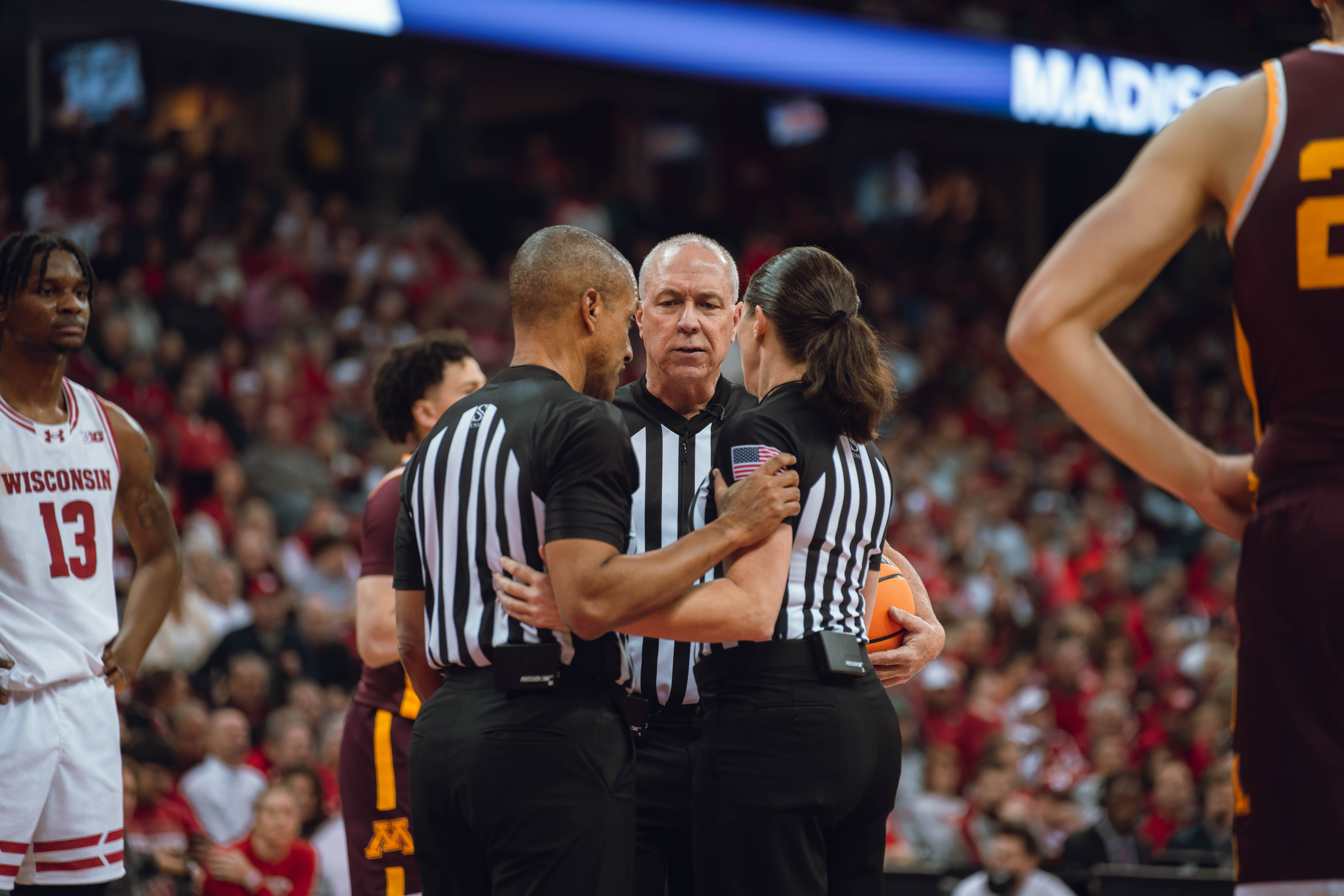 The officials converse about a possible flagrant 1 foul during the Wisconsin Badgers vs. Minnesota Golden Gophers game at Kohl Center on January 10, 2025 in Madison, Wisconsin. Photography by Ross Harried for Second Crop Sports.