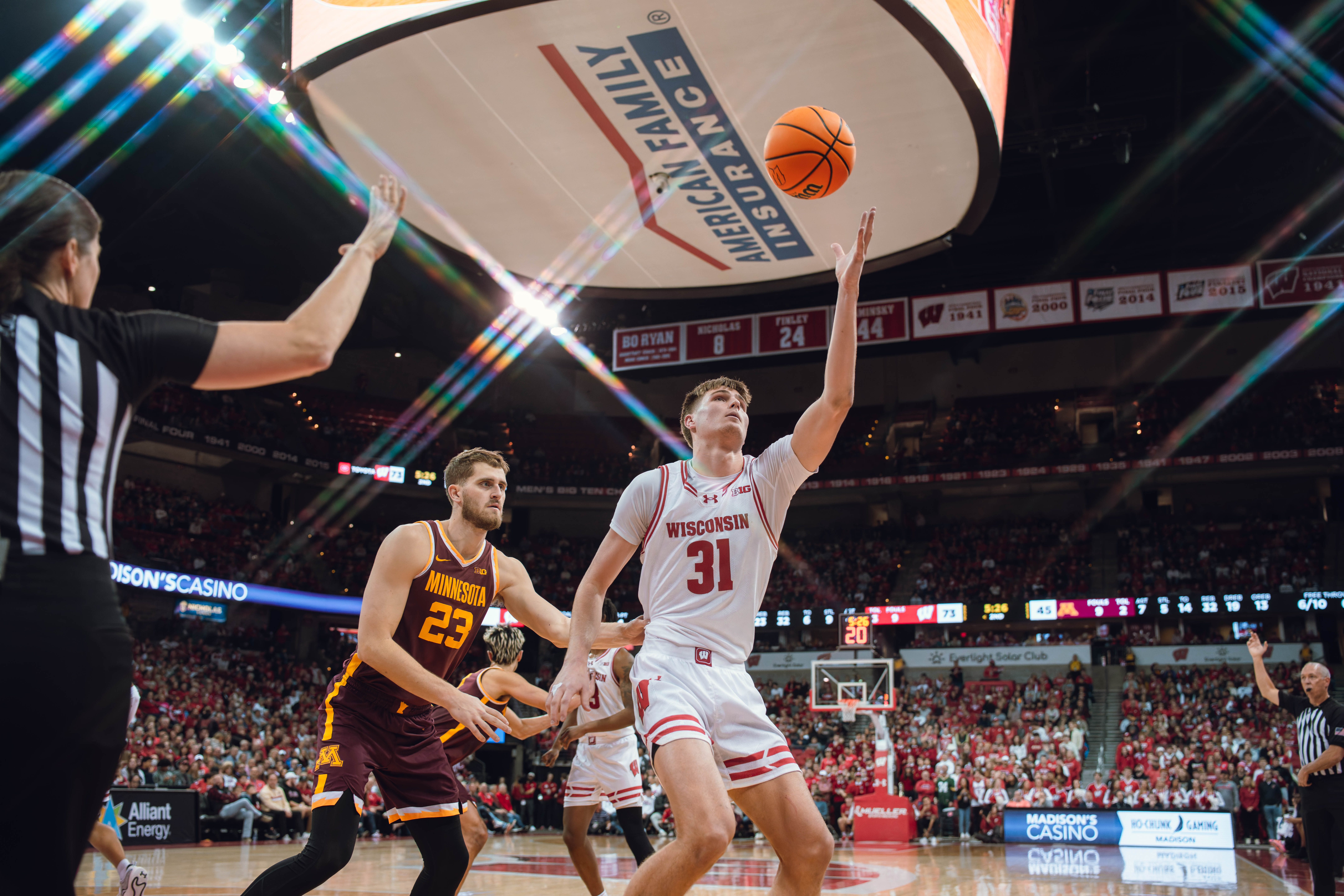 Wisconsin Badgers forward Nolan Winter #31 eyes an inbound pass while defended by Minnesota Golden Gophers forward Parker Fox #23 at Kohl Center on January 10, 2025 in Madison, Wisconsin. Photography by Ross Harried for Second Crop Sports.