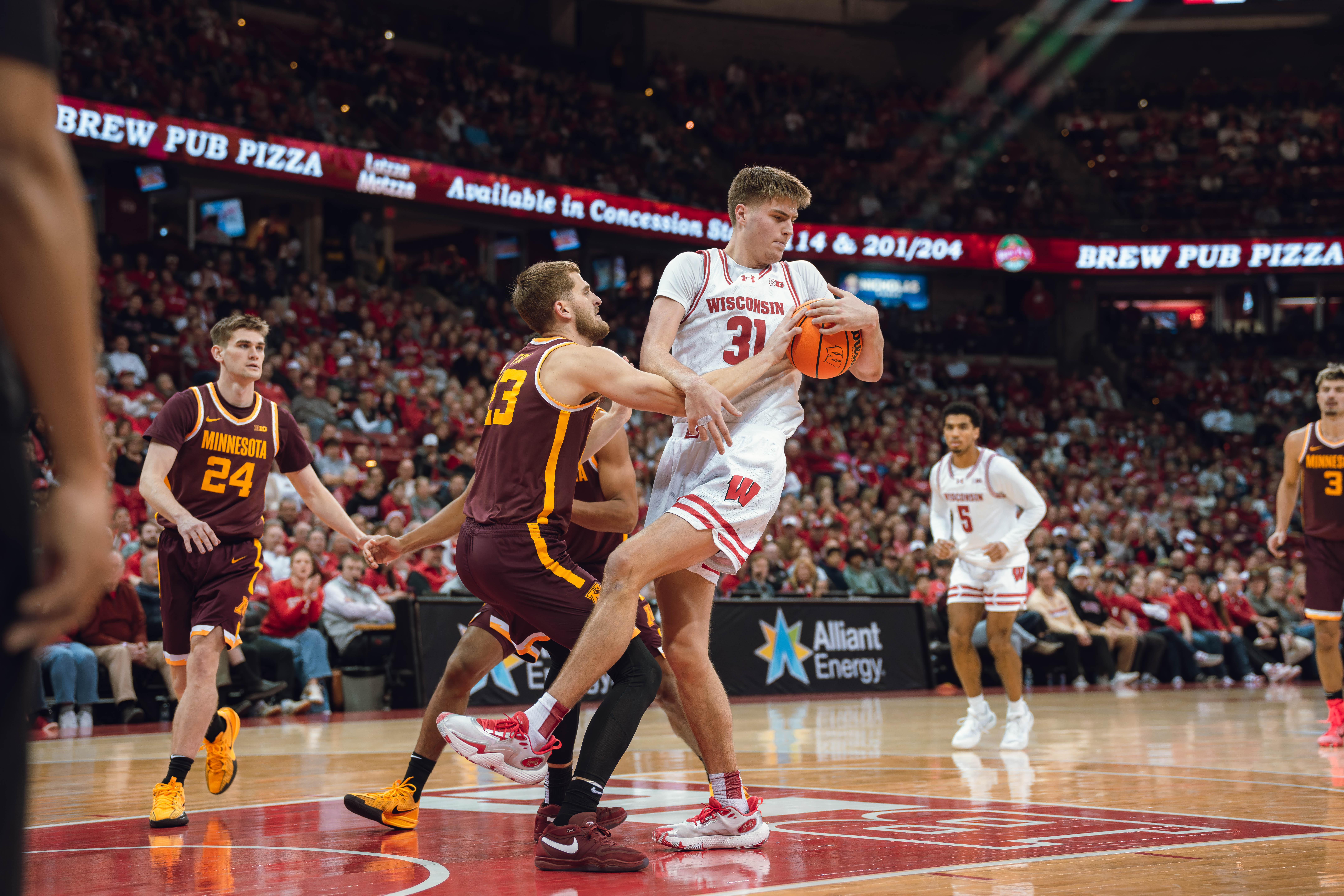 Wisconsin Badgers forward Nolan Winter #31 hauls in a rebound from Minnesota Golden Gophers forward Parker Fox #23 at Kohl Center on January 10, 2025 in Madison, Wisconsin. Photography by Ross Harried for Second Crop Sports.