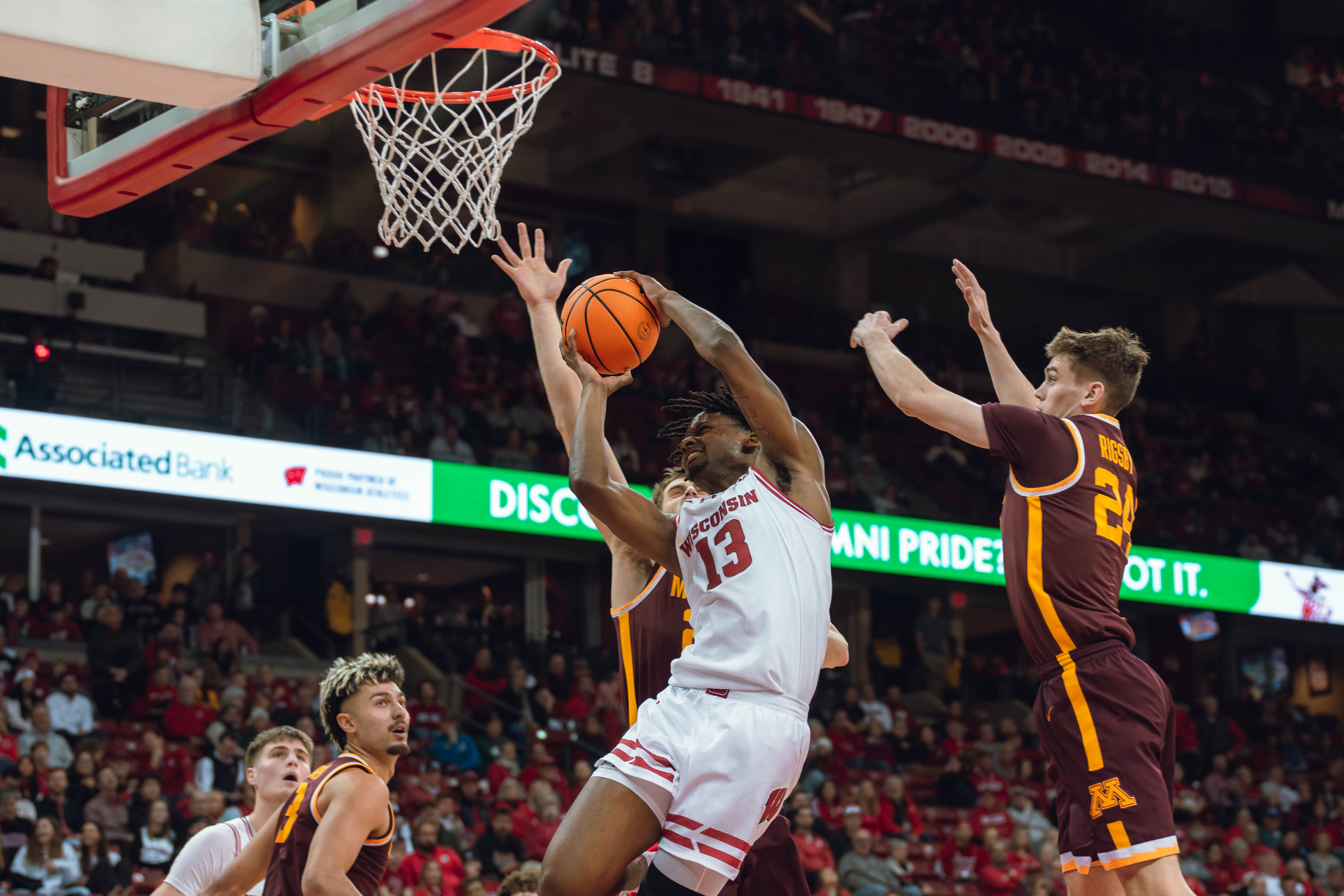 Wisconsin Badgers forward Xavier Amos #13 takes a hard foul against the Minnesota Golden Gophers at Kohl Center on January 10, 2025 in Madison, Wisconsin. Photography by Ross Harried for Second Crop Sports.