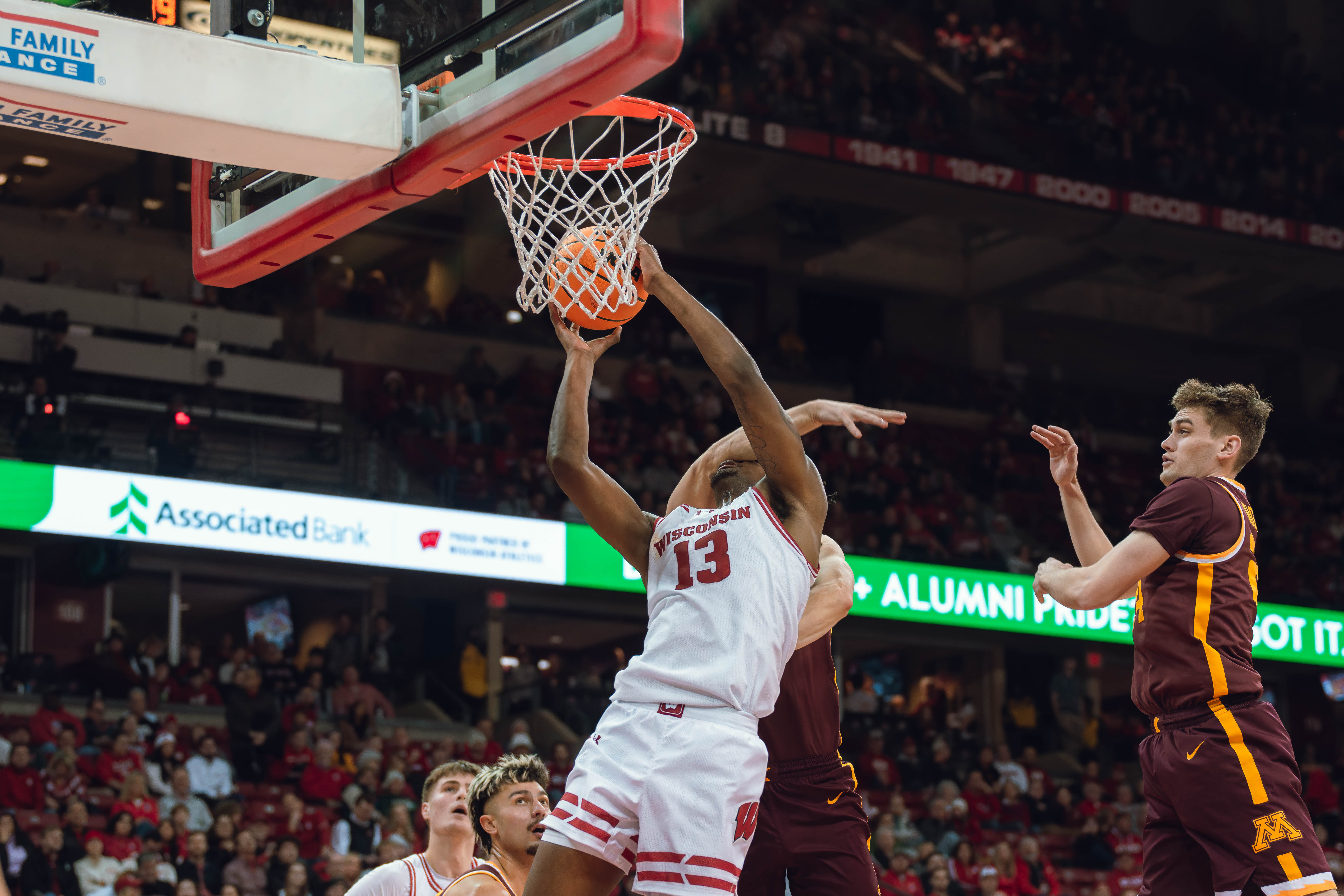 Wisconsin Badgers forward Xavier Amos #13 takes a hard foul against the Minnesota Golden Gophers at Kohl Center on January 10, 2025 in Madison, Wisconsin. Photography by Ross Harried for Second Crop Sports.