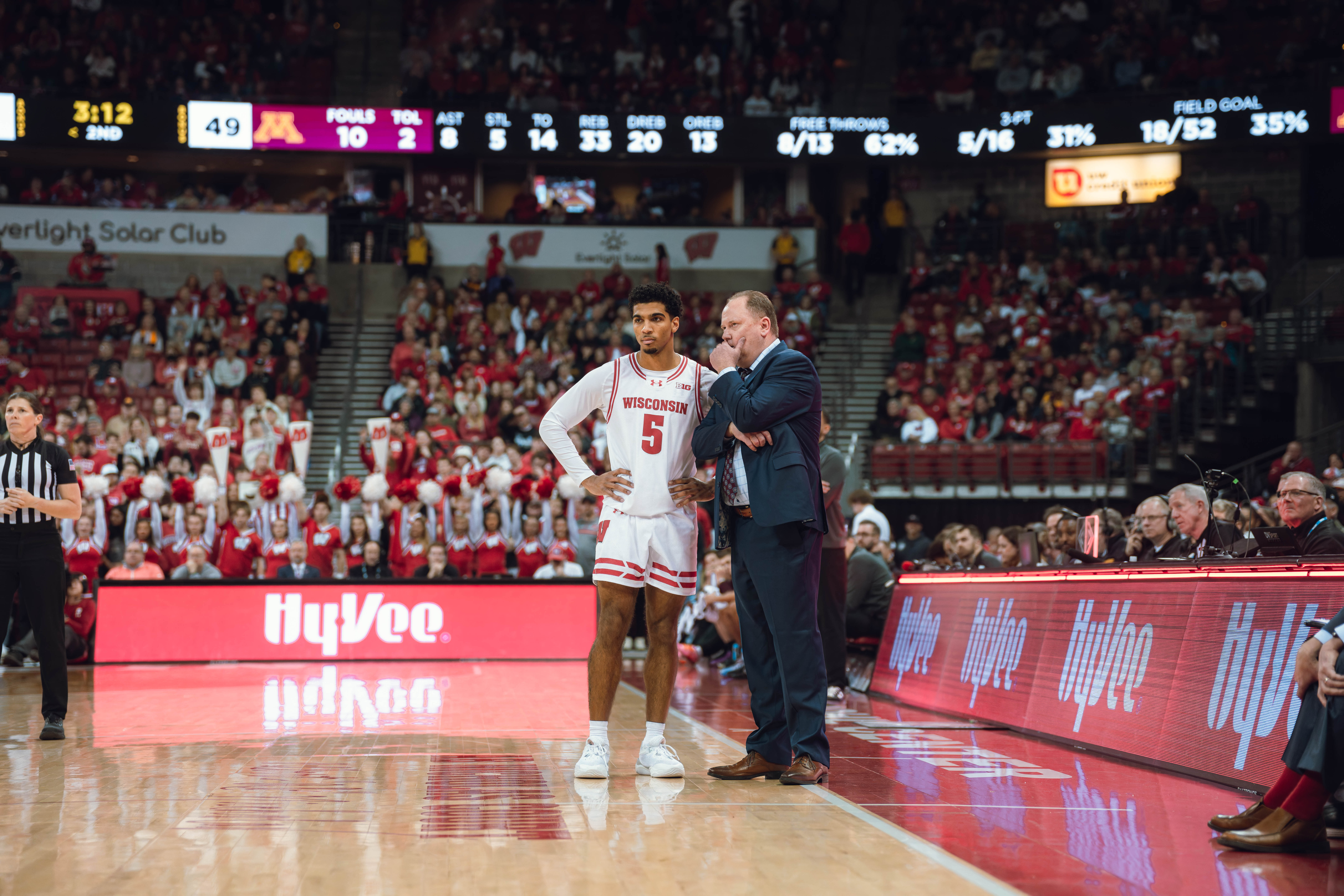 Wisconsin Badgers Head Coach Greg Gard talks to Wisconsin Badgers guard Daniel Freitag #5 during a game against the Minnesota Golden Gophers at Kohl Center on January 10, 2025 in Madison, Wisconsin. Photography by Ross Harried for Second Crop Sports.