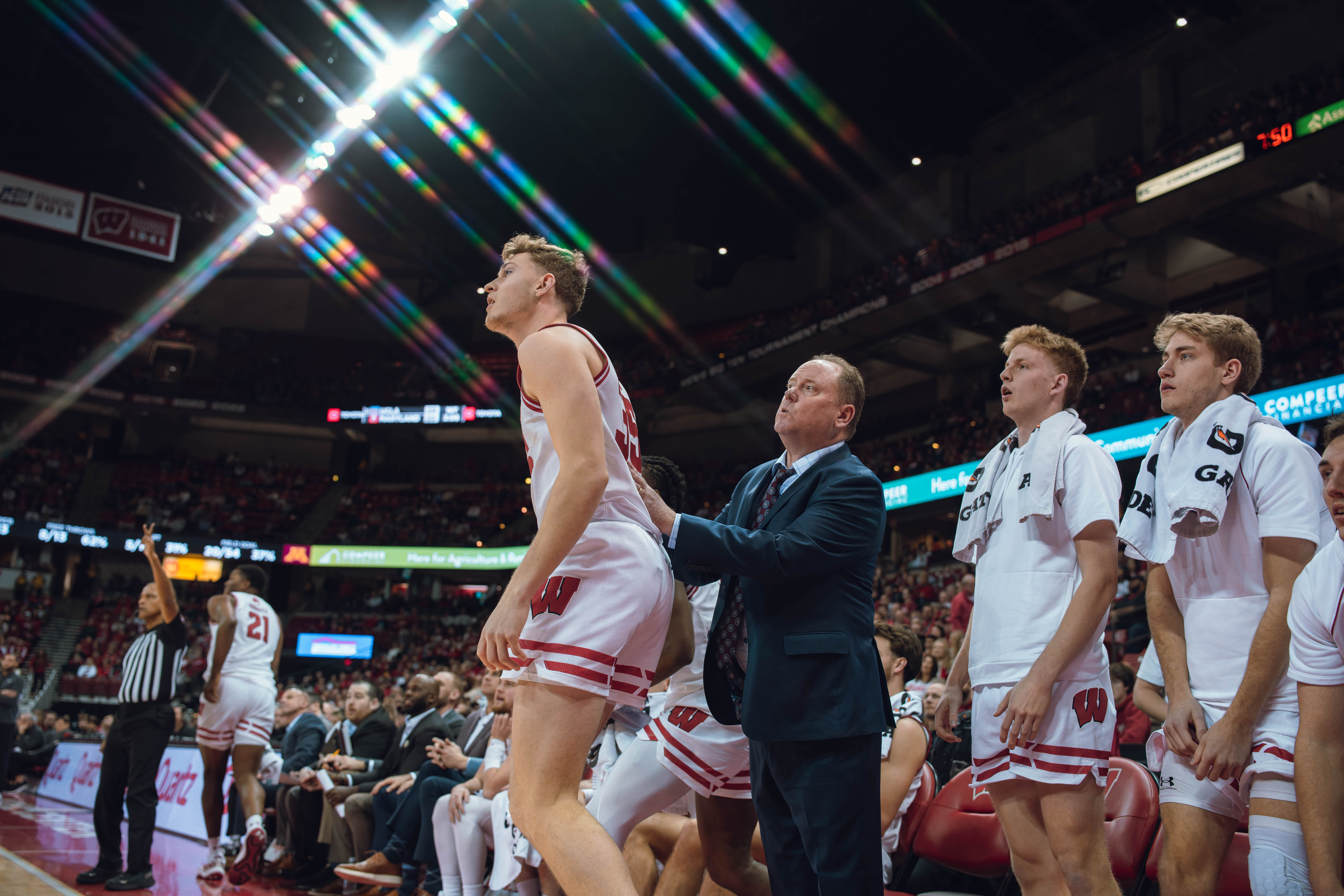 Wisconsin Badgers Head Coach Greg Gard looks past Wisconsin Badgers forward Markus Ilver #35 during a game against the Minnesota Golden Gophers at Kohl Center on January 10, 2025 in Madison, Wisconsin. Photography by Ross Harried for Second Crop Sports.