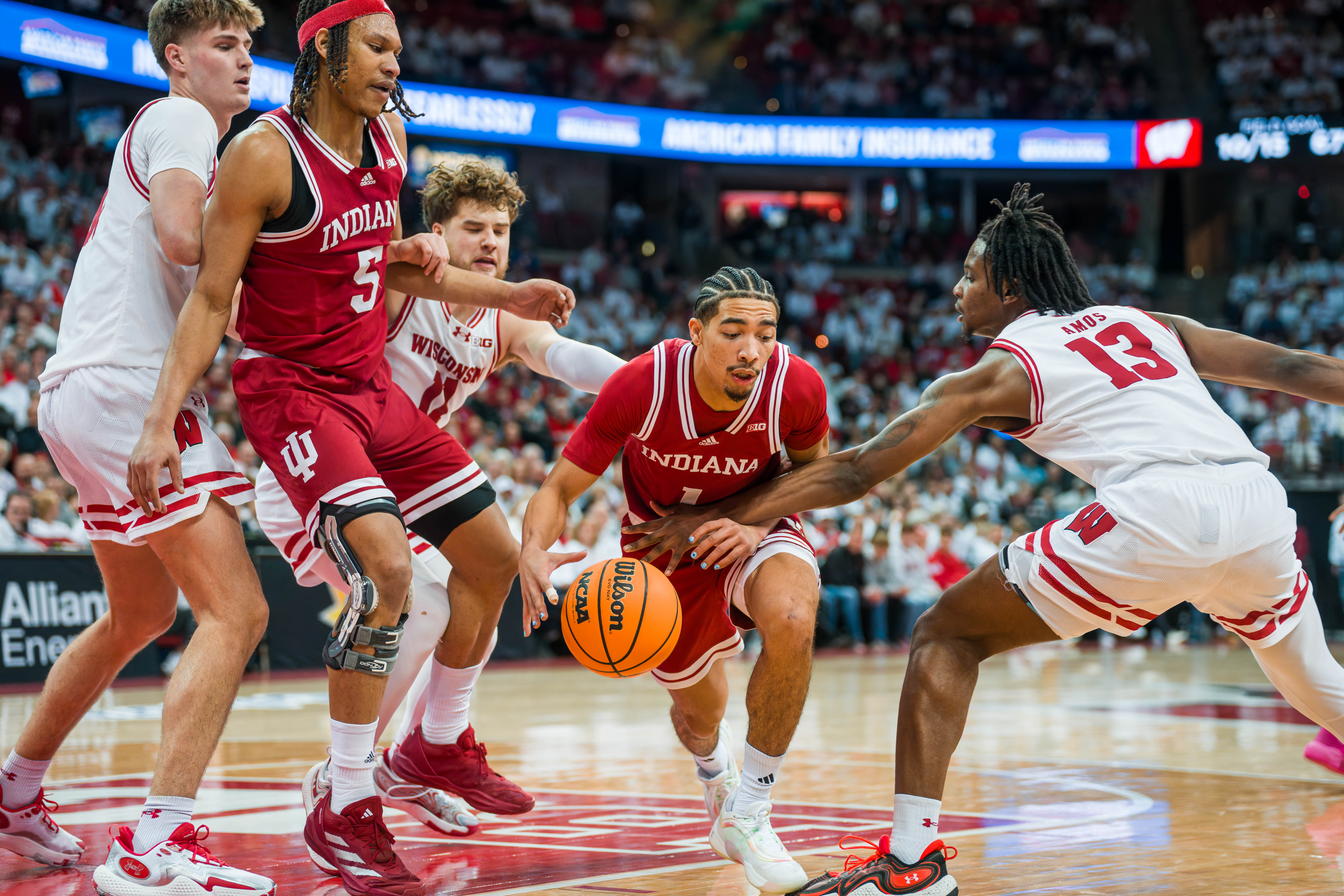 Indiana Hoosiers Guard Myles Rice #1 drives past Wisconsin Badgers guard Max Klesmit #11 and Wisconsin Badgers forward Xavier Amos #13 Wisconsin Badgers vs. Indiana Hoosiers at the Kohl Center on February 04, 2025 in Madison, Wisconsin. Photography by Ross Harried for Second Crop Sports.