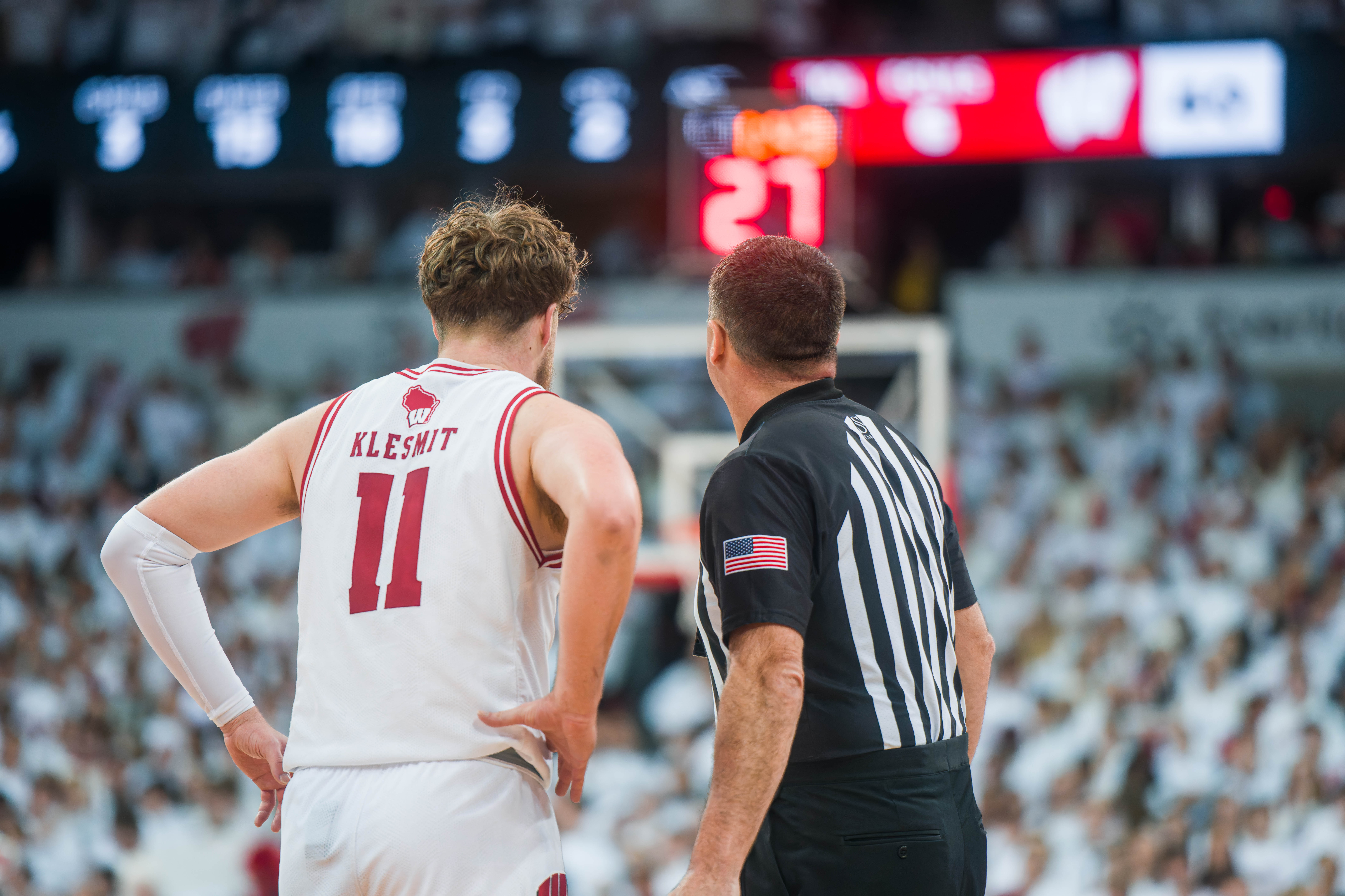 Wisconsin Badgers guard Max Klesmit #11 has a conversation with a referee against the Indiana Hoosiers at the Kohl Center on February 04, 2025 in Madison, Wisconsin. Photography by Ross Harried for Second Crop Sports.