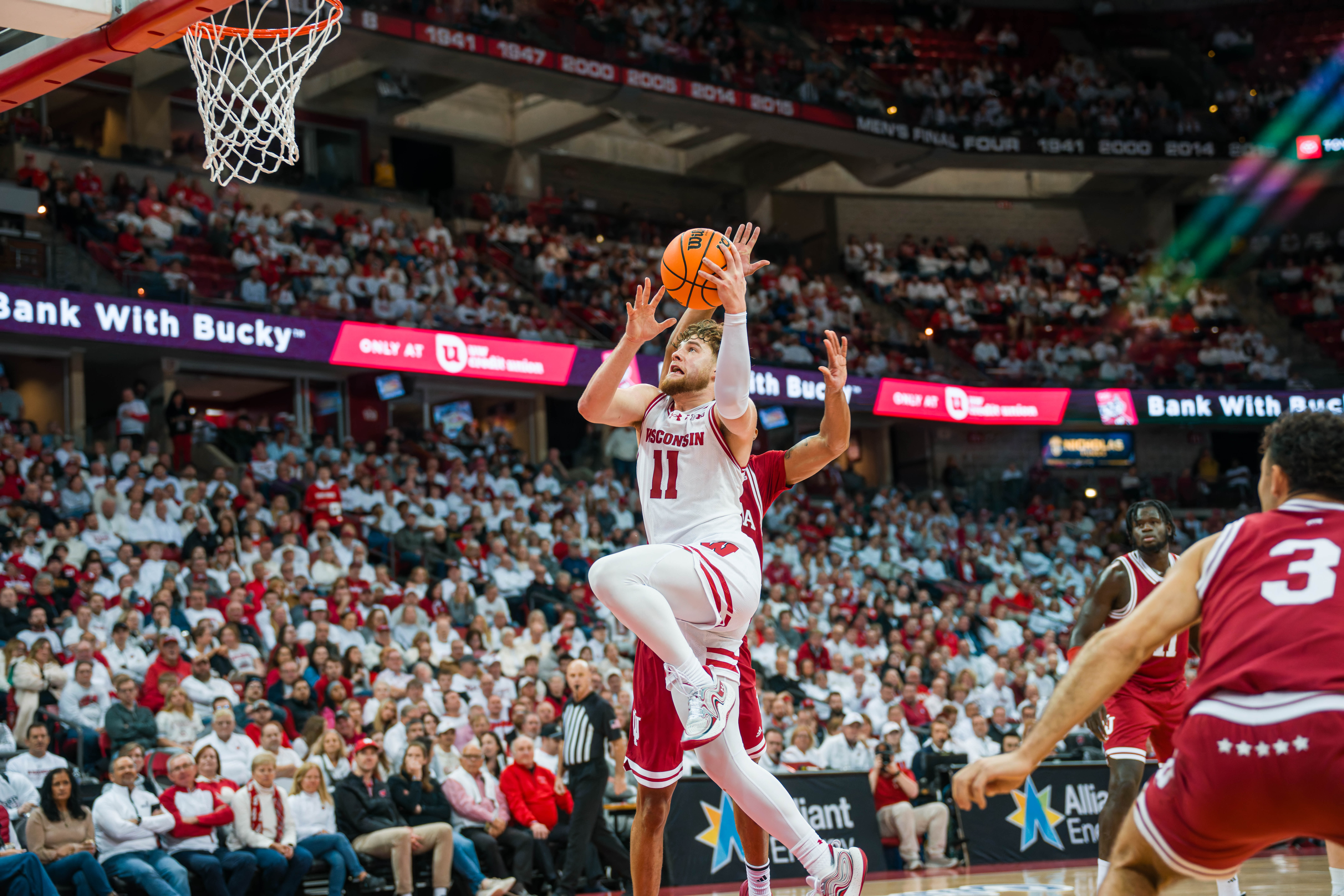 Wisconsin Badgers guard Max Klesmit #11 drive the lane against the Indiana Hoosiers at the Kohl Center on February 04, 2025 in Madison, Wisconsin. Photography by Ross Harried for Second Crop Sports.