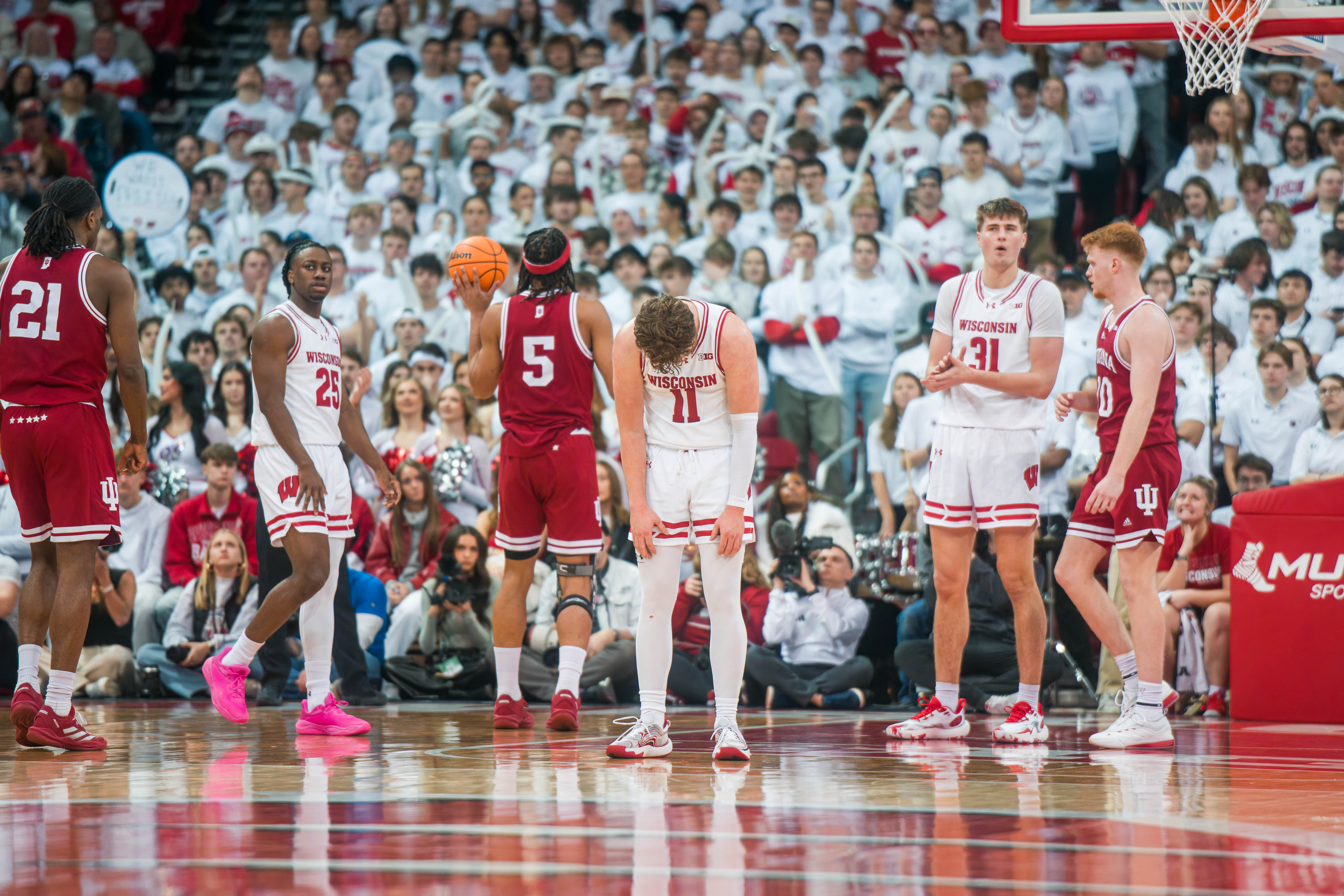 Wisconsin Badgers guard Max Klesmit #11 lowers his head after committing a foul against the Indiana Hoosiers at the Kohl Center on February 04, 2025 in Madison, Wisconsin. Photography by Ross Harried for Second Crop Sports.