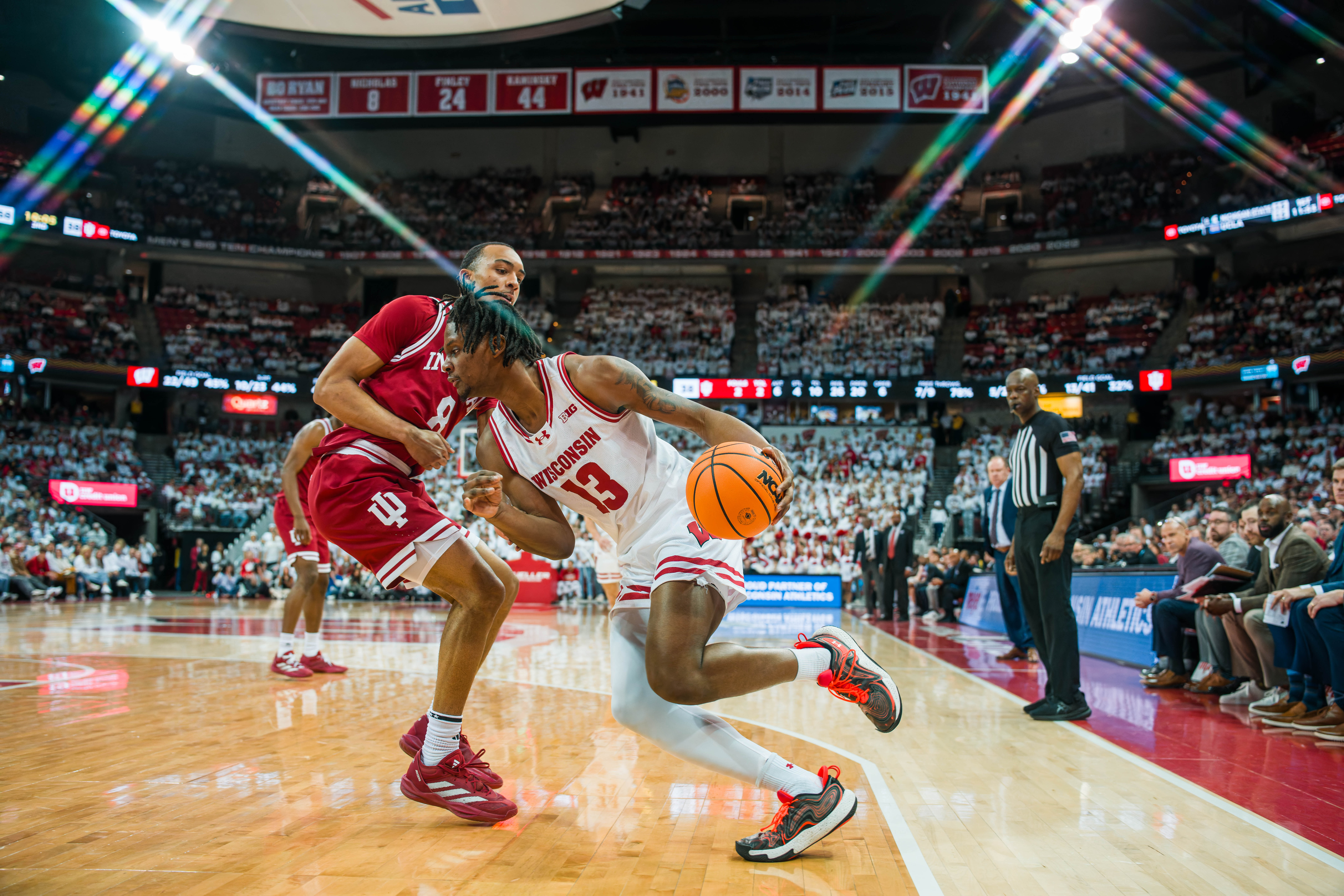 Wisconsin Badgers forward Xavier Amos #13 drives the baseline past Indiana Hoosiers Forward Bryson Tucker #8 at the Kohl Center on February 04, 2025 in Madison, Wisconsin. Photography by Ross Harried for Second Crop Sports.