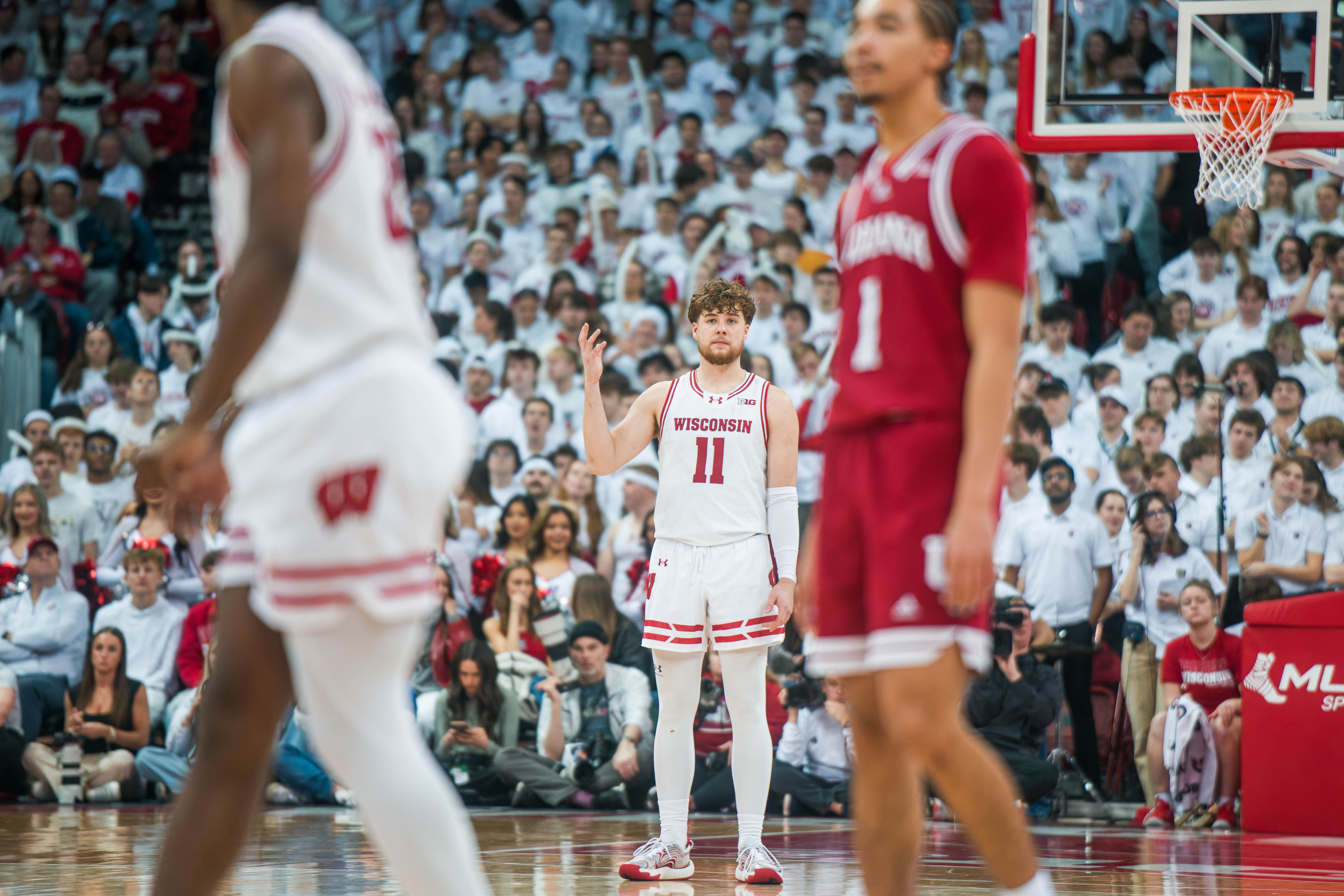 A confused Wisconsin Badgers guard Max Klesmit #11 looks for reassurance during an Indiana Hoosiers free throw at the Kohl Center on February 04, 2025 in Madison, Wisconsin. Photography by Ross Harried for Second Crop Sports.