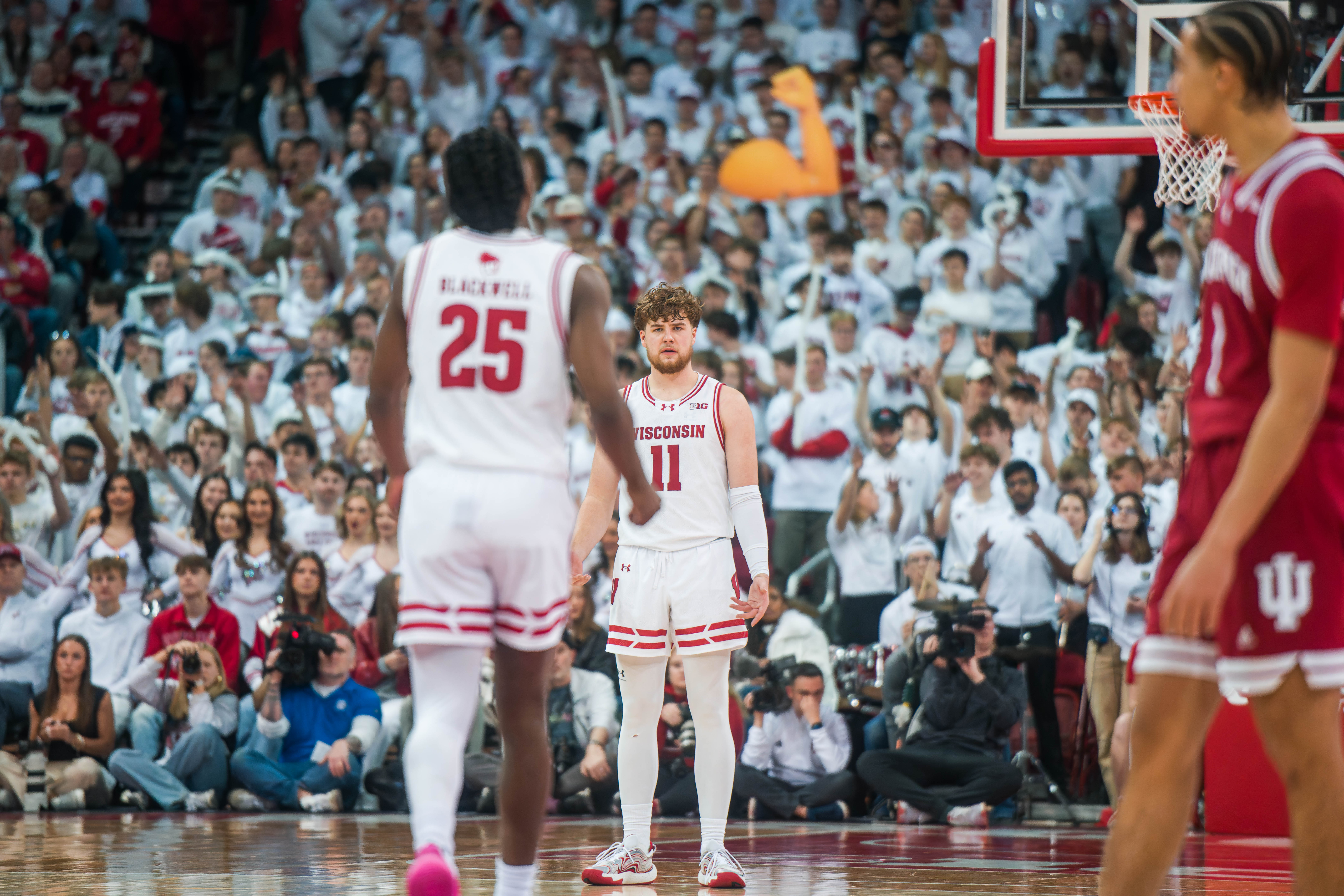 A confused Wisconsin Badgers guard Max Klesmit #11 looks for reassurance during an Indiana Hoosiers free throw at the Kohl Center on February 04, 2025 in Madison, Wisconsin. Photography by Ross Harried for Second Crop Sports.