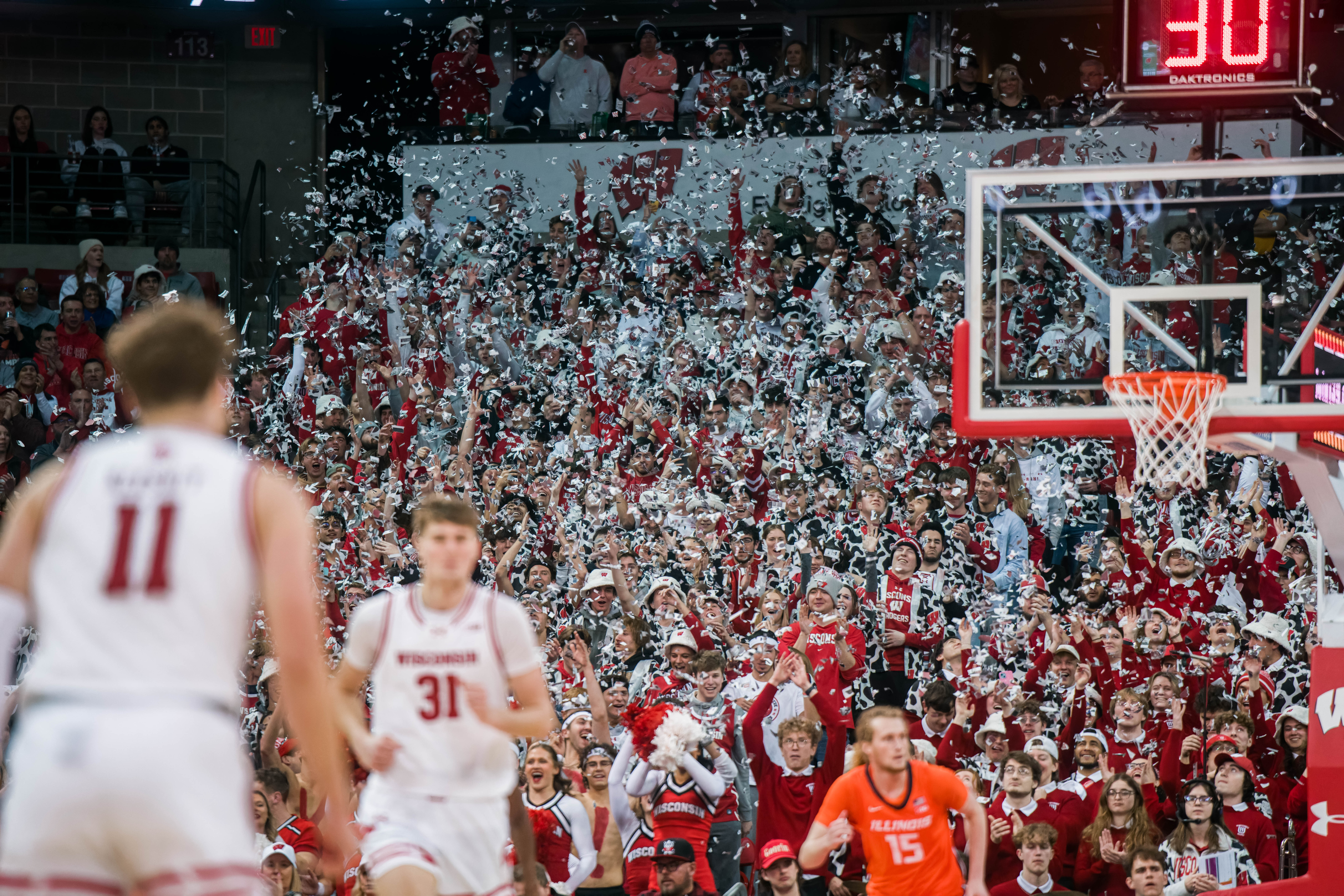 The Wisconsin Badgers student section explodes with white confetti after the first made field goal of the game for the Badgers against the Illinois Fighting Illini at The Kohl Center on February 18, 2025 in Madison, Wisconsin. Photography by Ross Harried for Second Crop Sports.