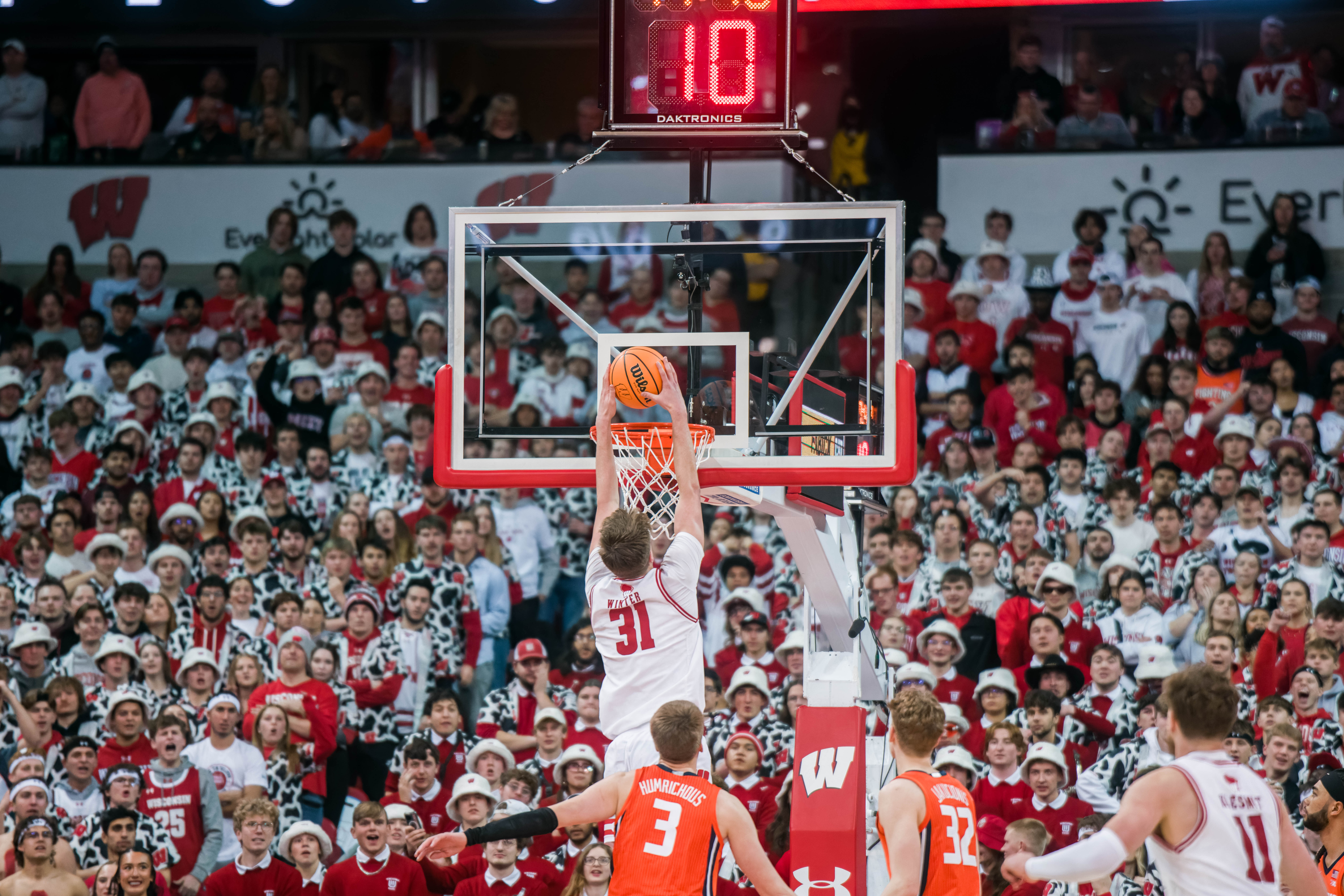 Wisconsin Badgers forward Nolan Winter #31 slams an easy dunk against the Illinois Fighting Illini at The Kohl Center on February 18, 2025 in Madison, Wisconsin. Photography by Ross Harried for Second Crop Sports.