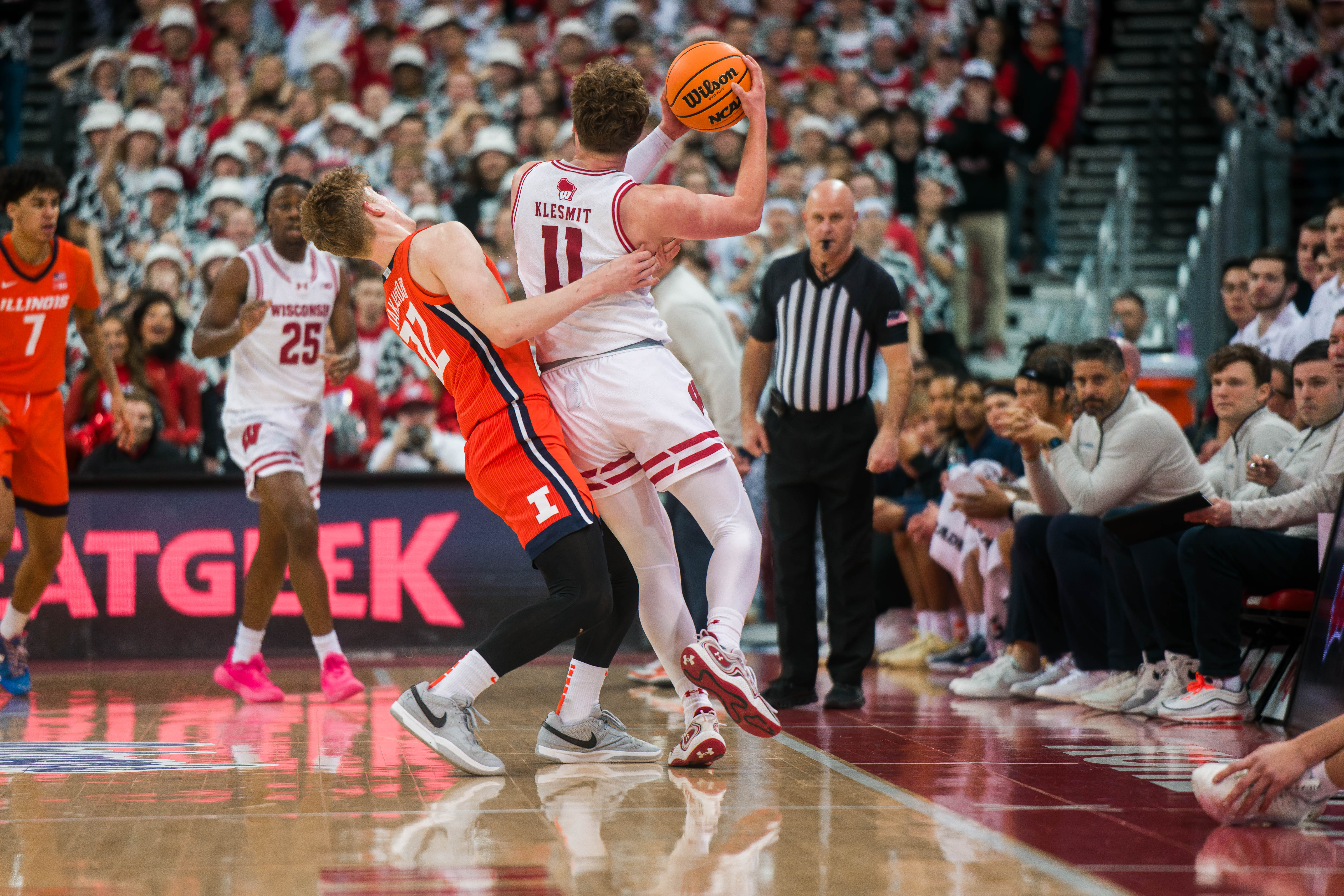 Wisconsin Badgers guard Max Klesmit #11 is fouled by Illinois Fighting Illini guard Kasparas Jakucionis #32 at The Kohl Center on February 18, 2025 in Madison, Wisconsin. Photography by Ross Harried for Second Crop Sports.