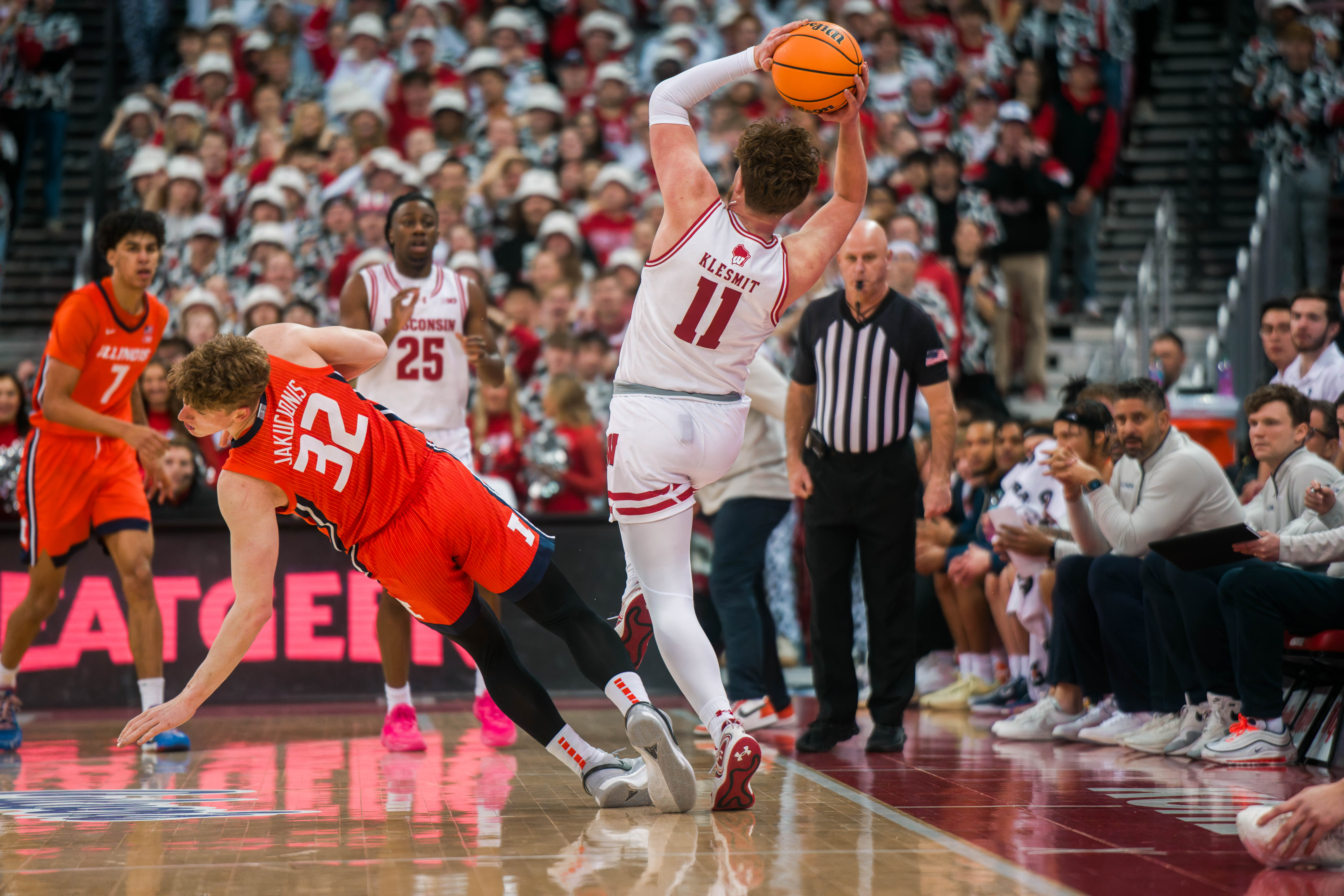 Wisconsin Badgers guard Max Klesmit #11 is fouled by Illinois Fighting Illini guard Kasparas Jakucionis #32 at The Kohl Center on February 18, 2025 in Madison, Wisconsin. Photography by Ross Harried for Second Crop Sports.